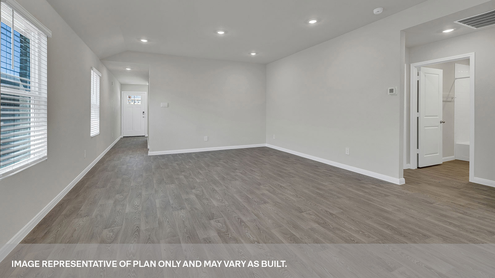 Living room with vinyl flooring and entry hallway.