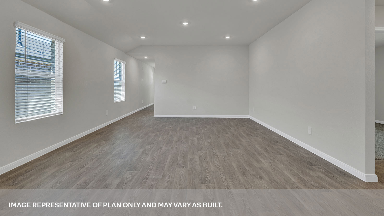 Dining room and living room with vinyl flooring and 2 windows.