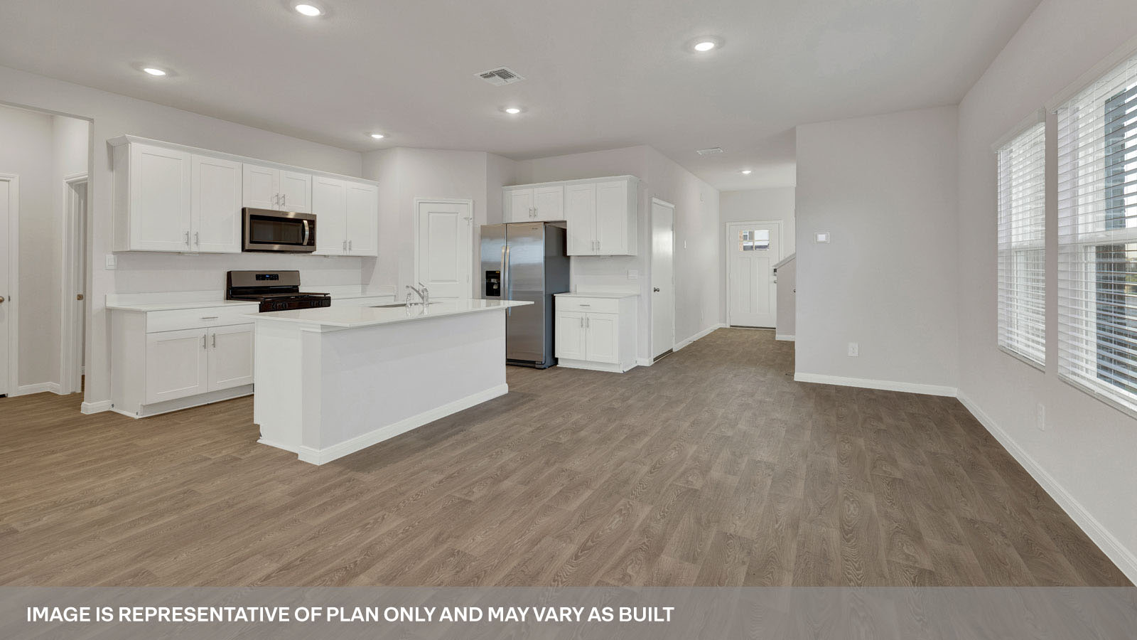 kitchen with white cabinetry, large island, and stainless steel appliances