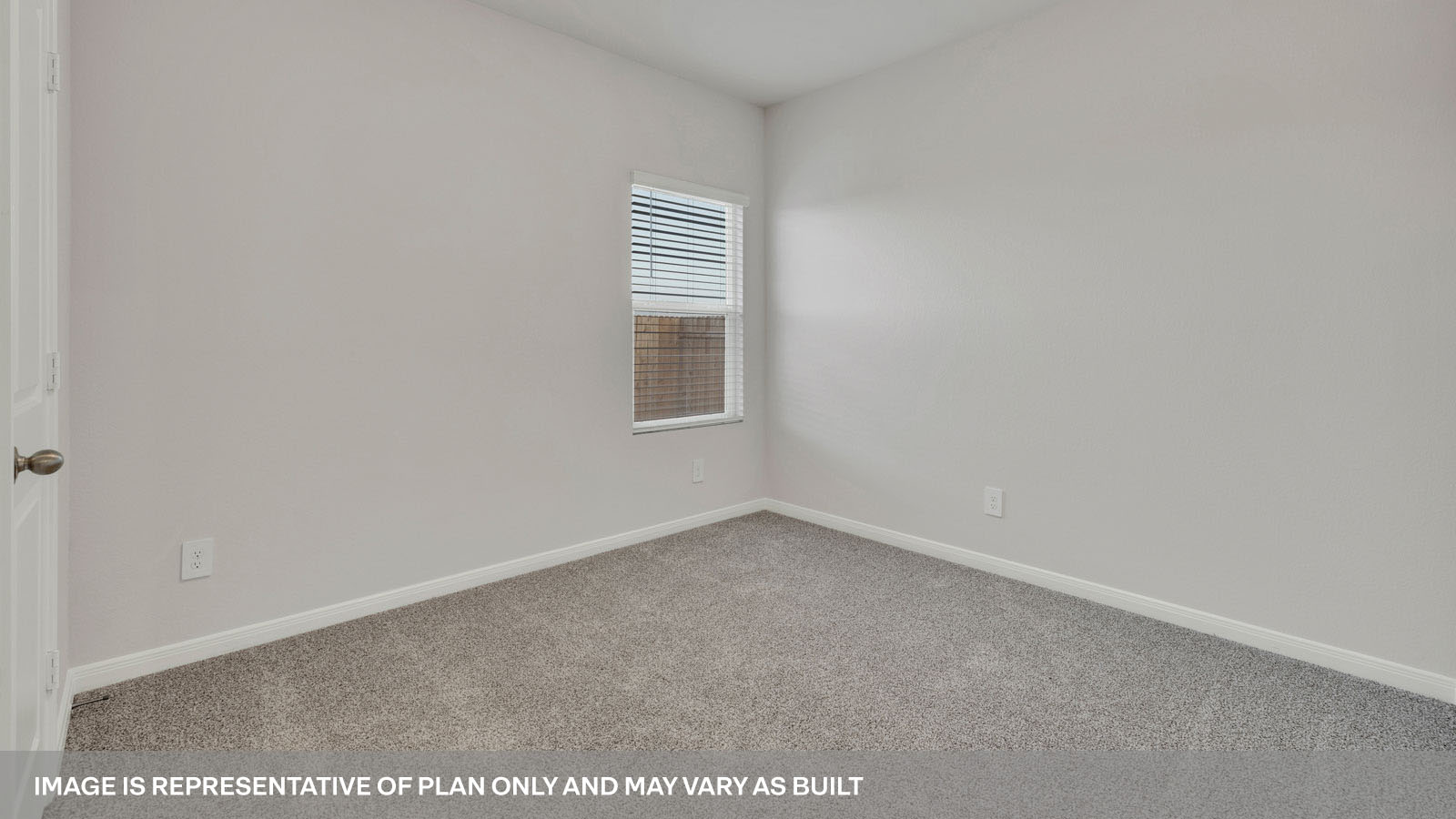 bedroom with beige carpet, white walls and a window