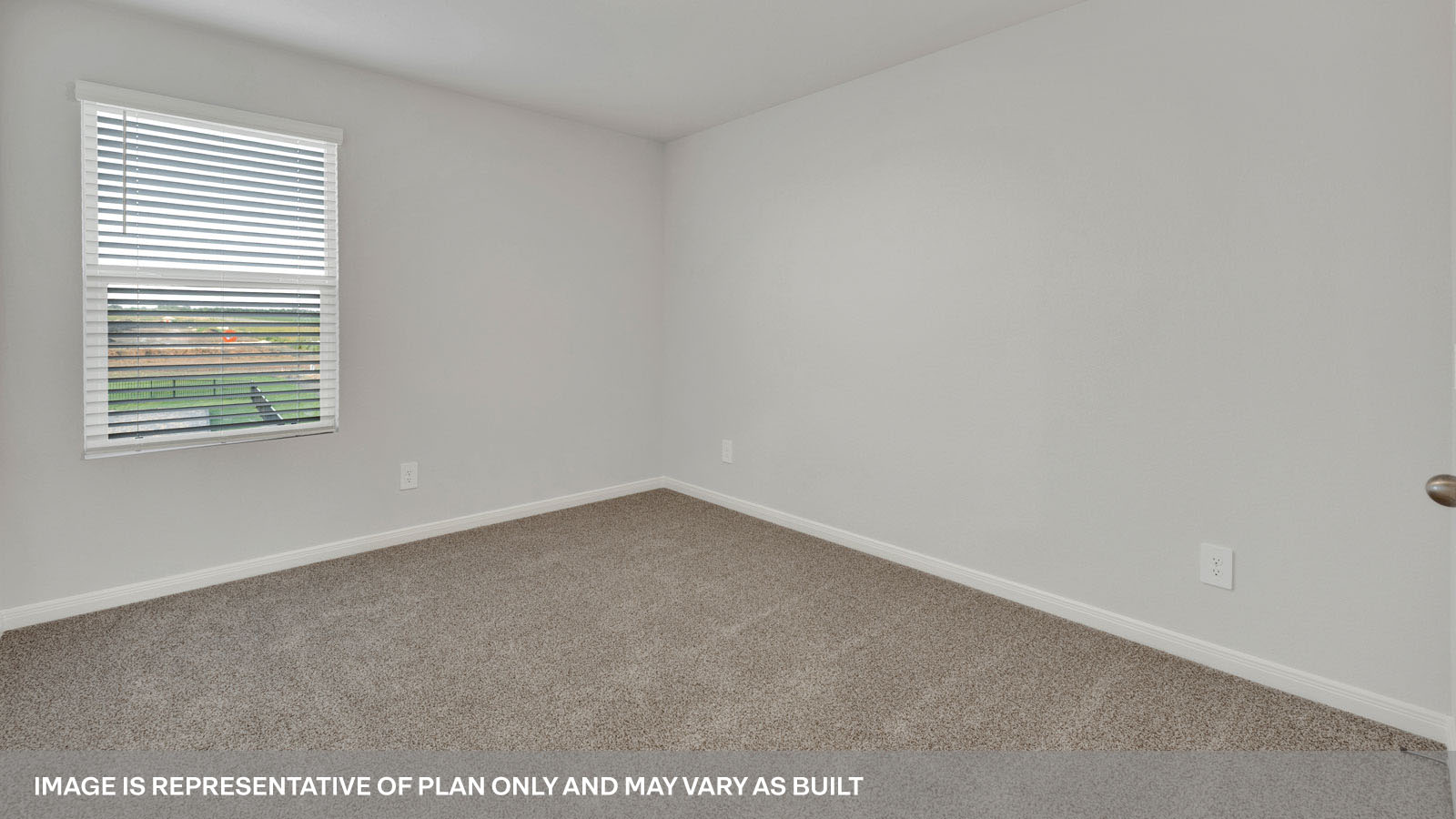bedroom with beige carpet, white walls and a window