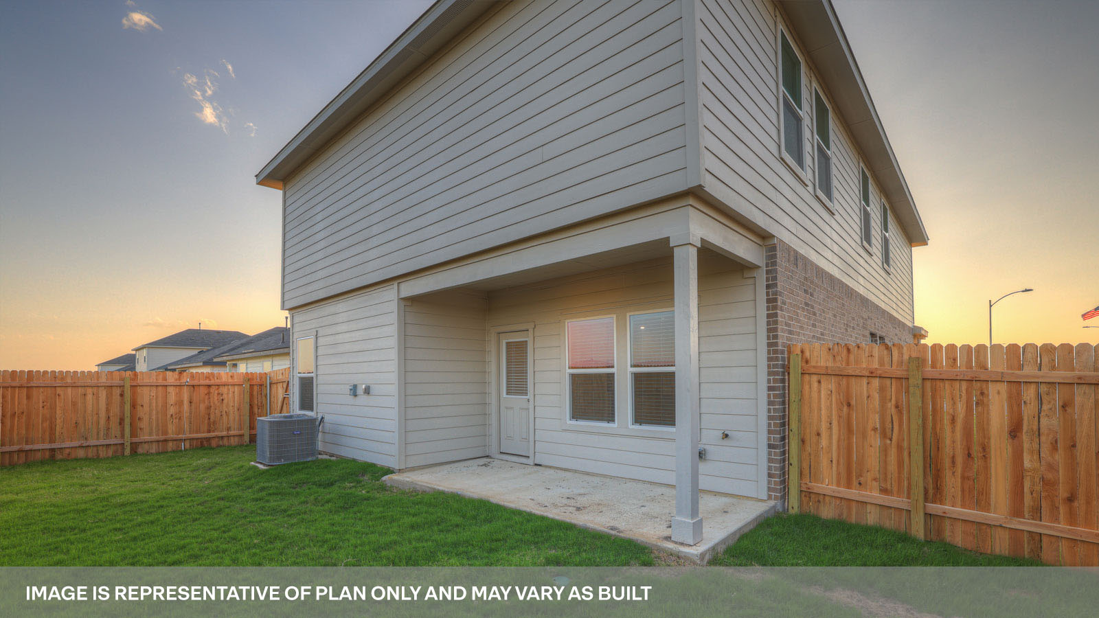 rear exterior of home featuring a spacious fenced in backyard