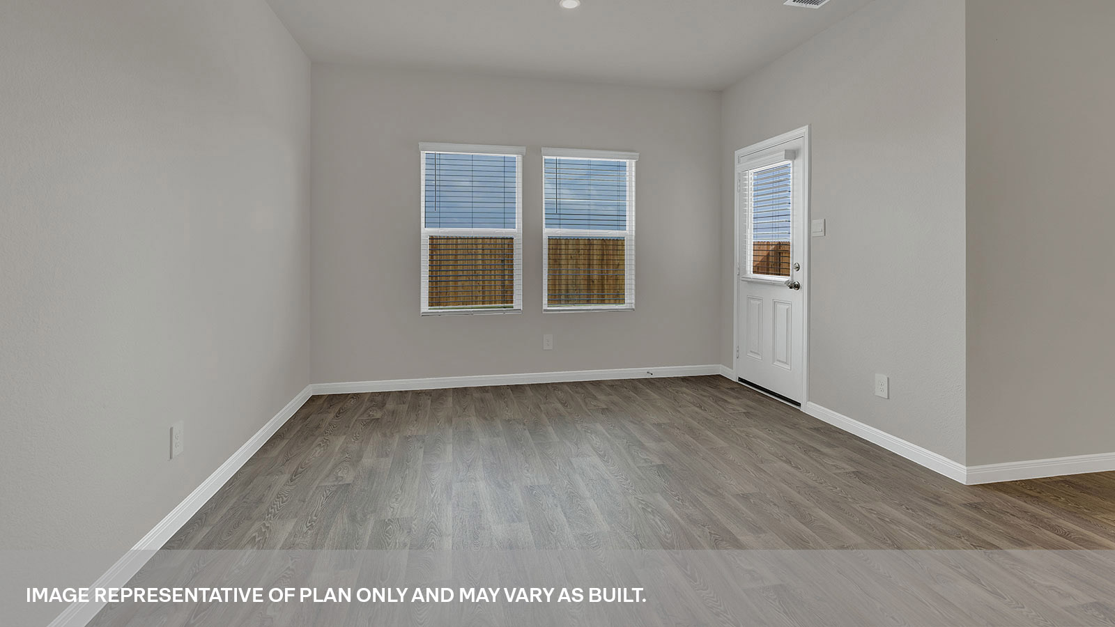 Dining room with vinyl flooring and two windows.