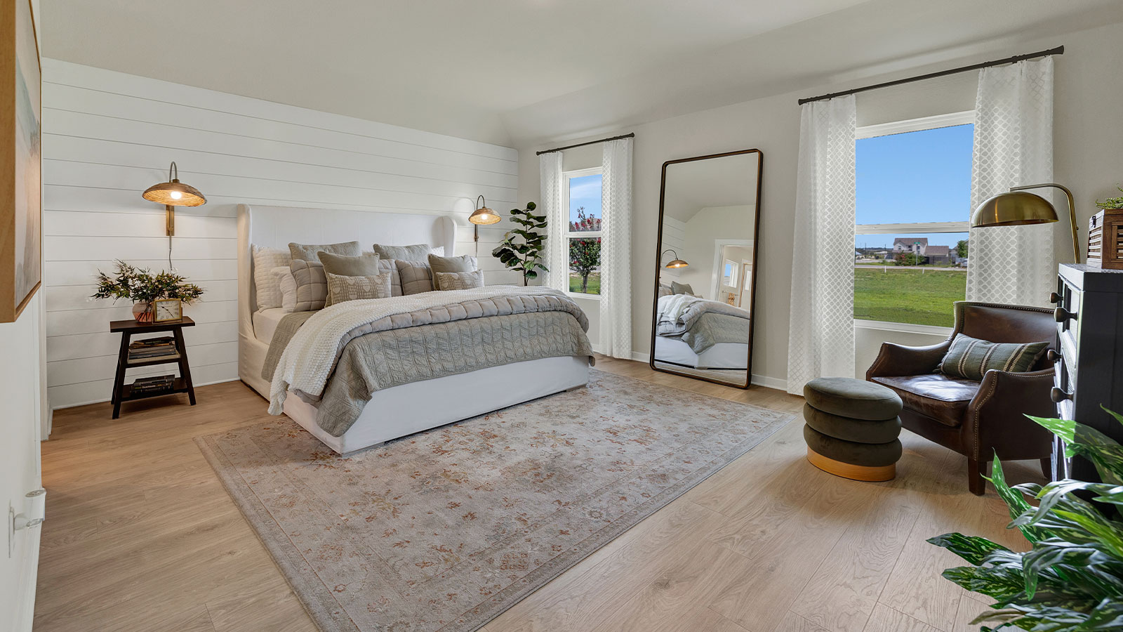 Main bedroom with carpeting and two windows.