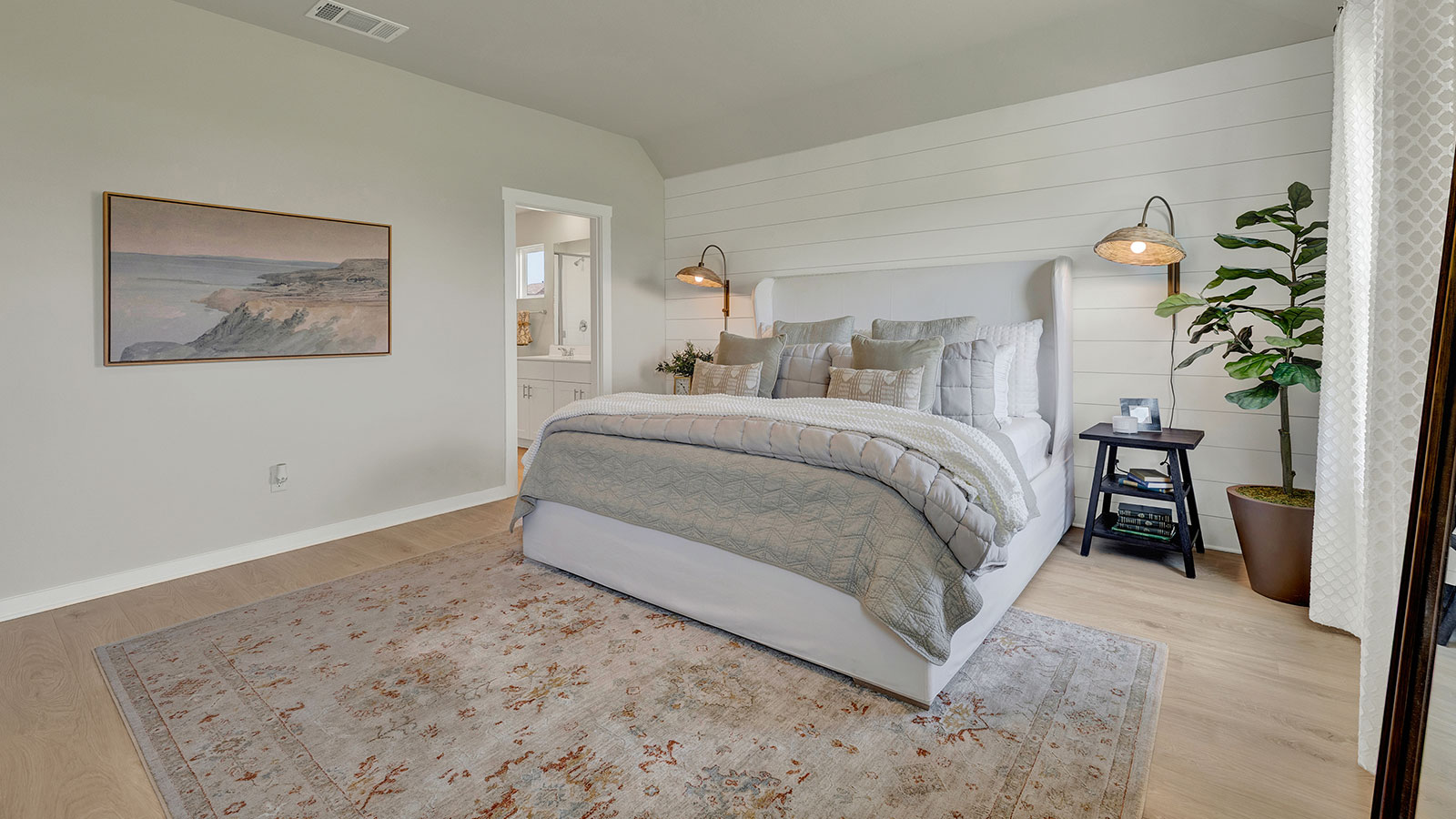 Main bedroom with carpeting and two windows.