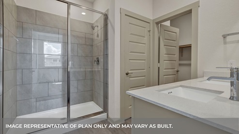 Main bathroom with a large walk in shower and double vanity.