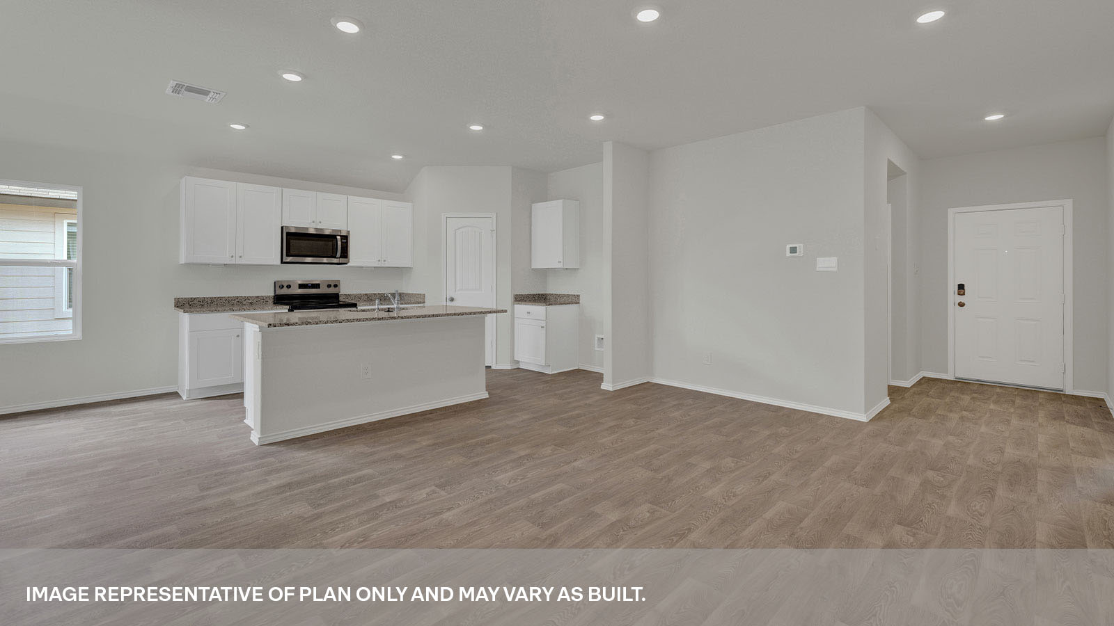 Living room leading to the kitchen and front door.