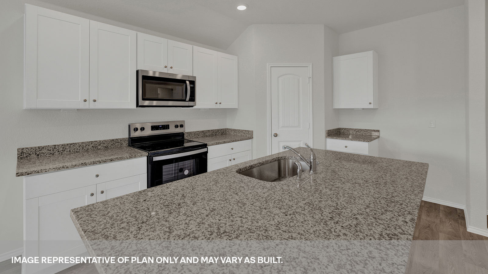 Large kitchen island with granite countertops appliances.