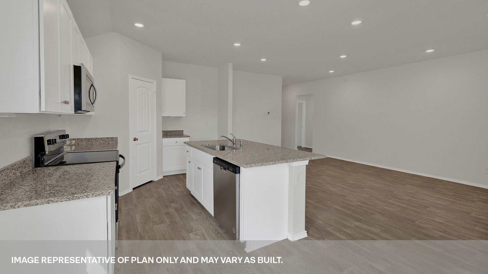 Kitchen with a kitchen island and large sink looking into the living room.