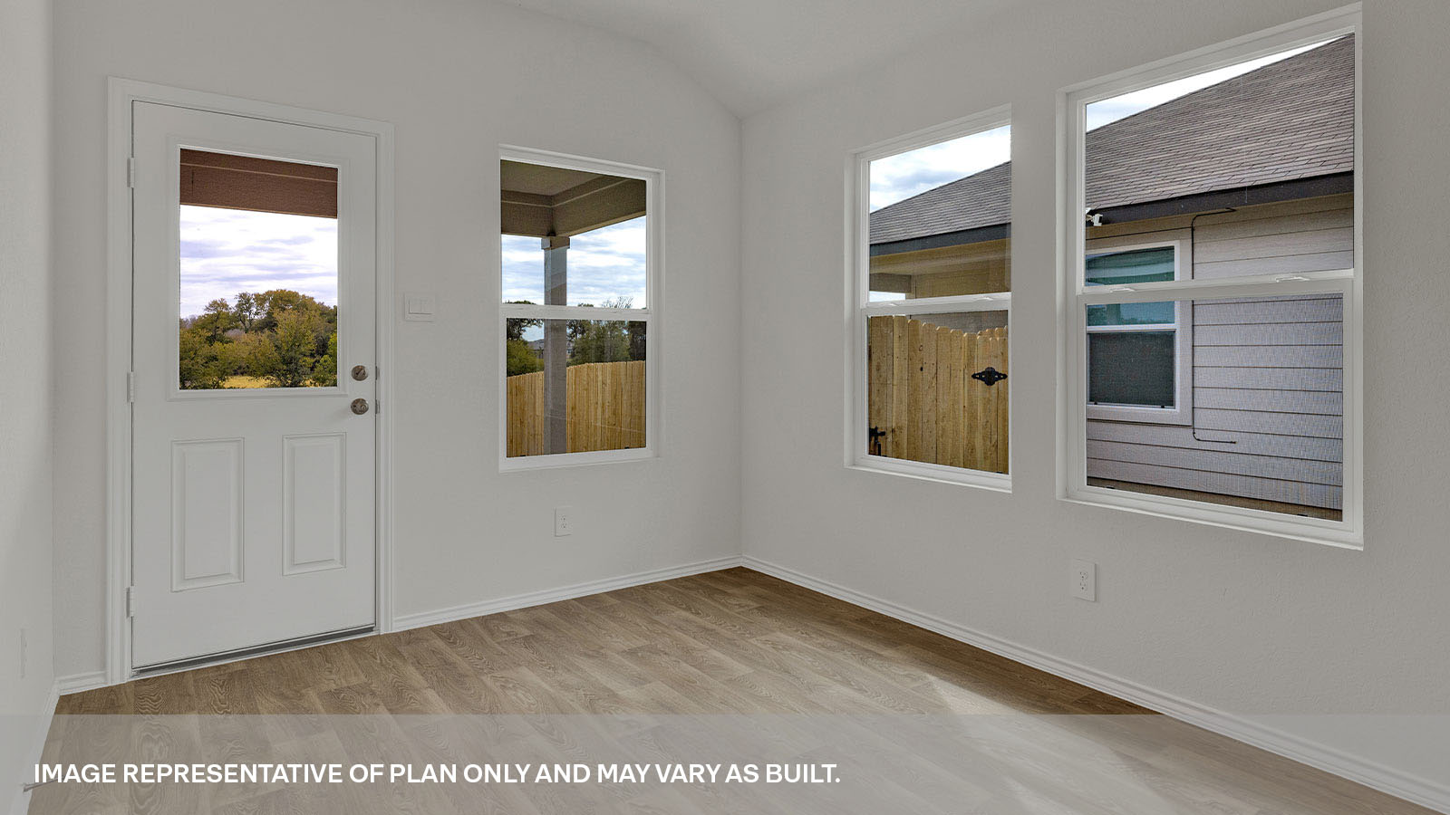 Dining area with 2 windows and a backdoor with a half-lite window.
