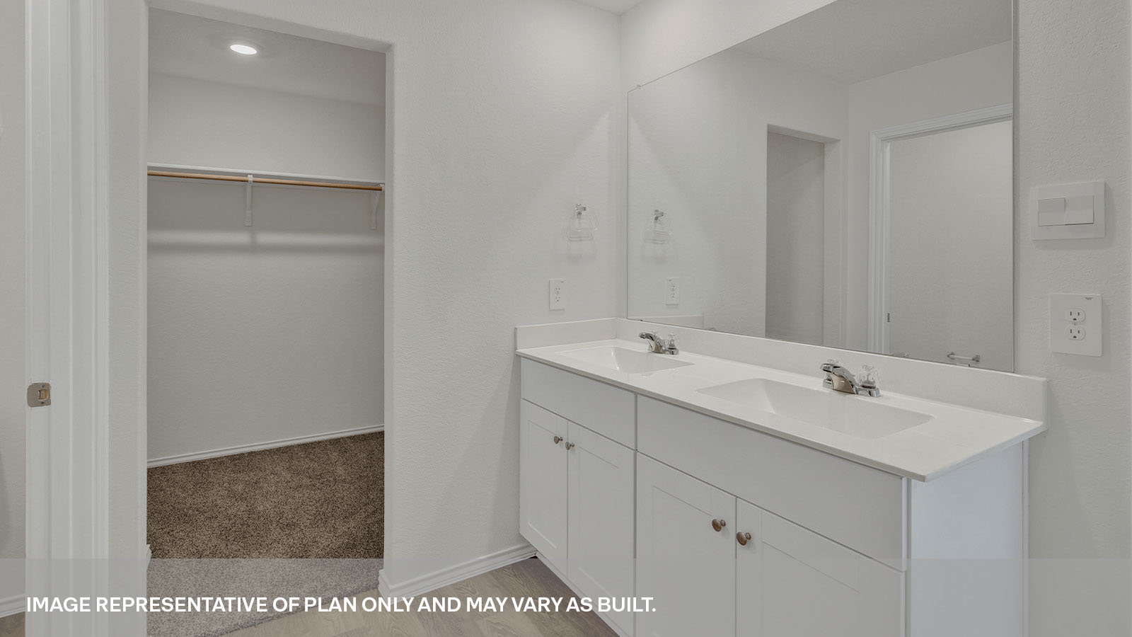 Main bathroom with a large walk-in closet and a double sink in a large vanity.
