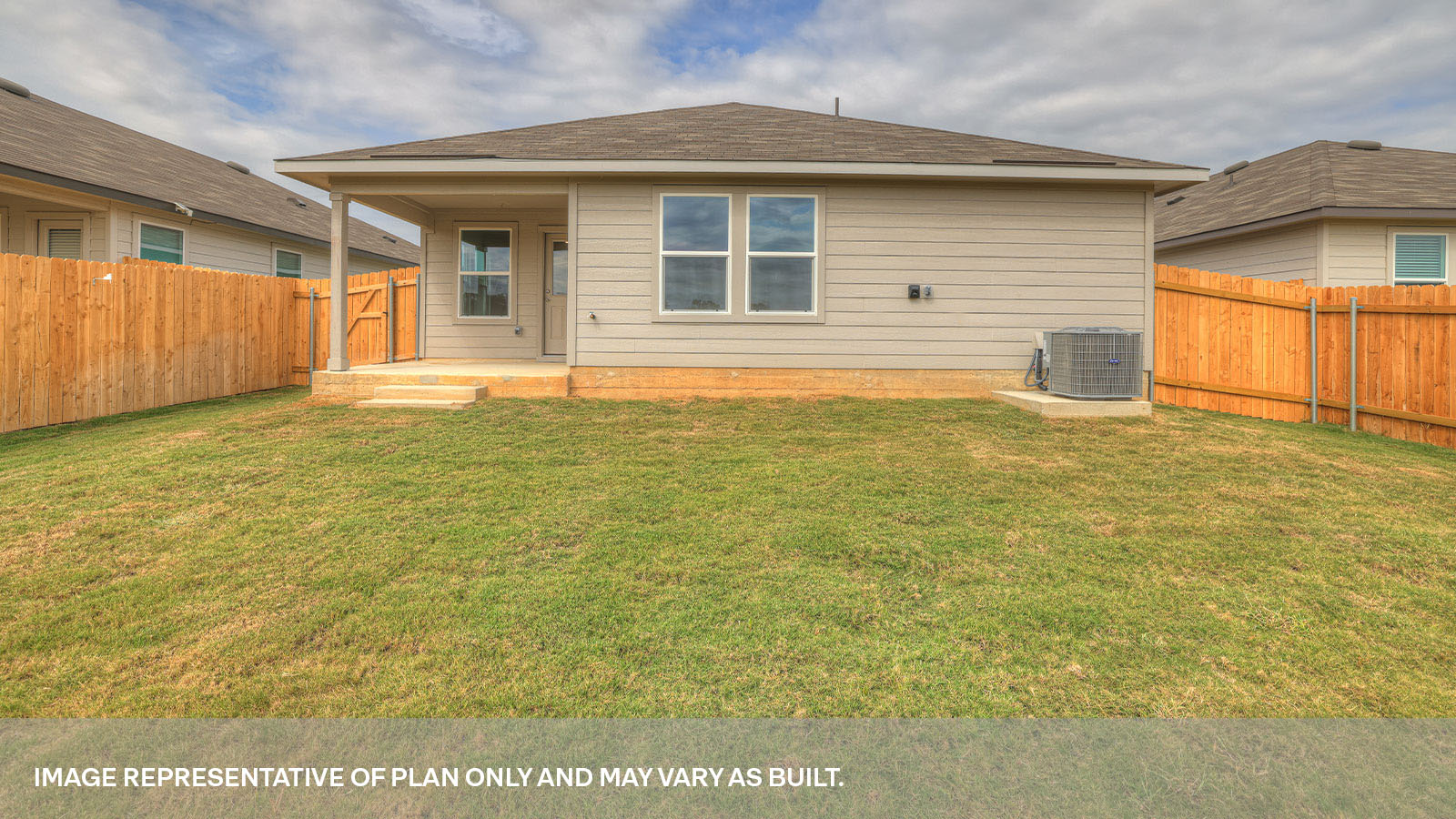 Covered back patio with windows and door with half lite window.