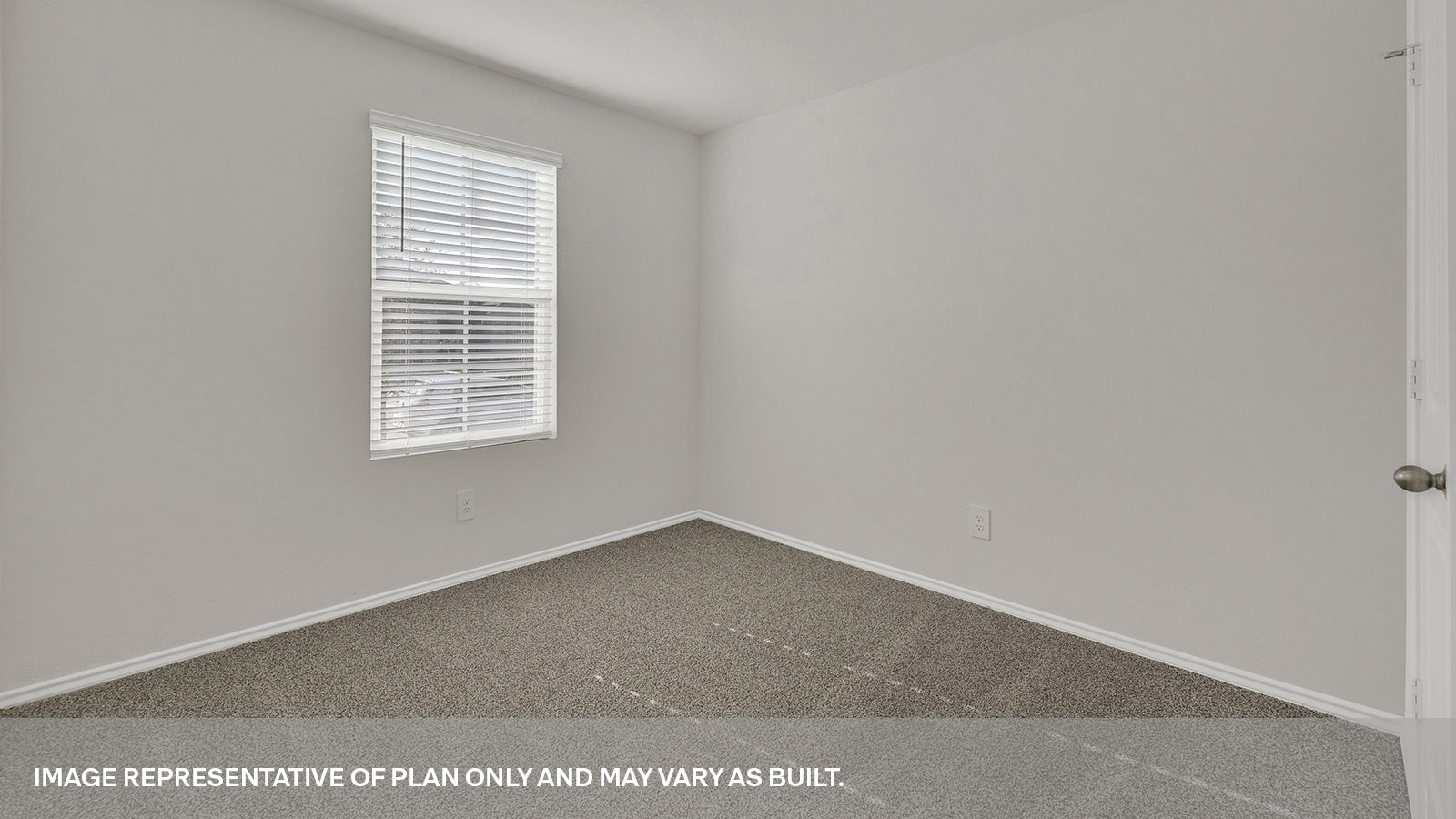 Front bedroom with carpeting and a window showing the front yard.