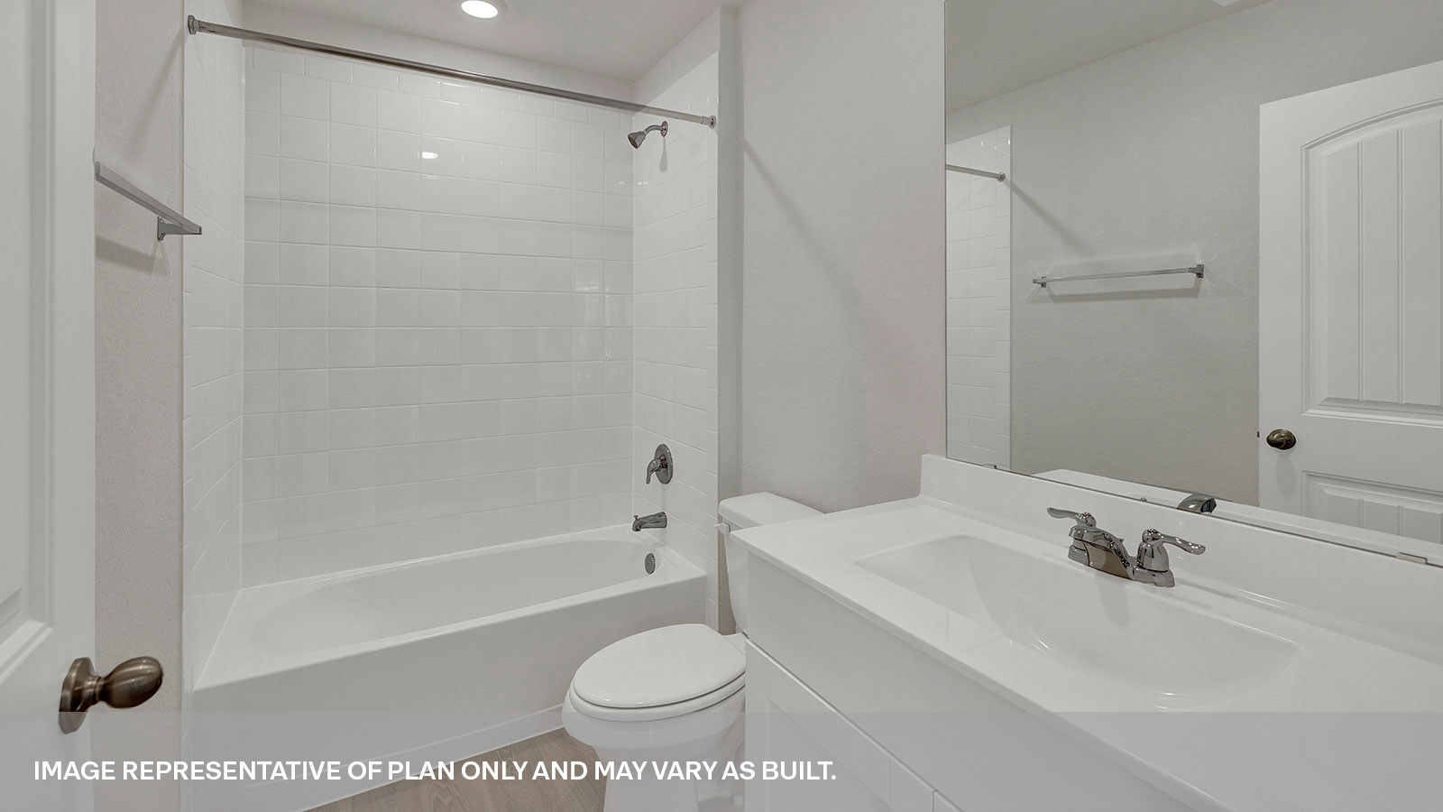 Bathroom with a tile surround shower/tub combo and white cabinets.