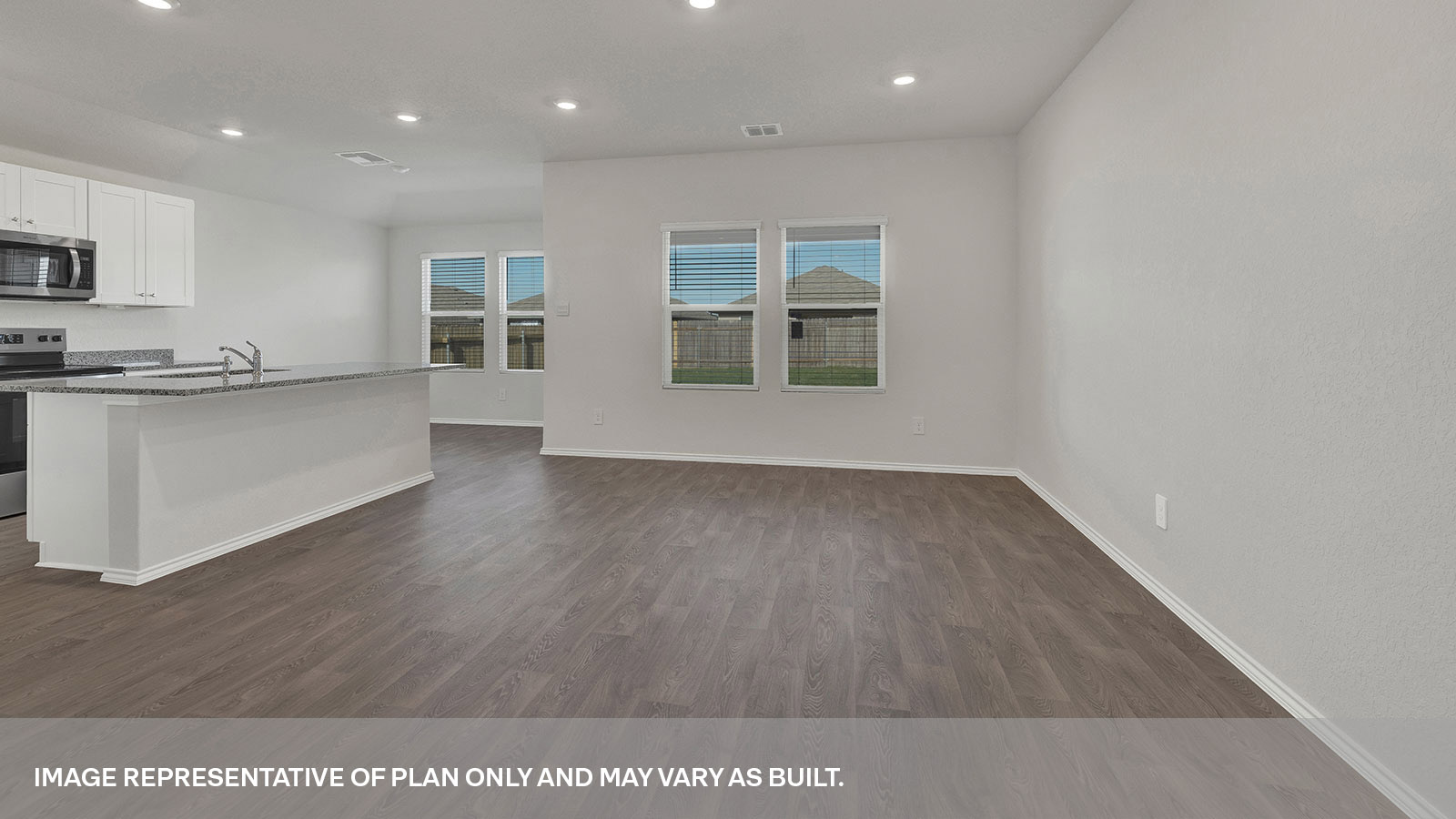 Living room leading to the front door and kitchen.