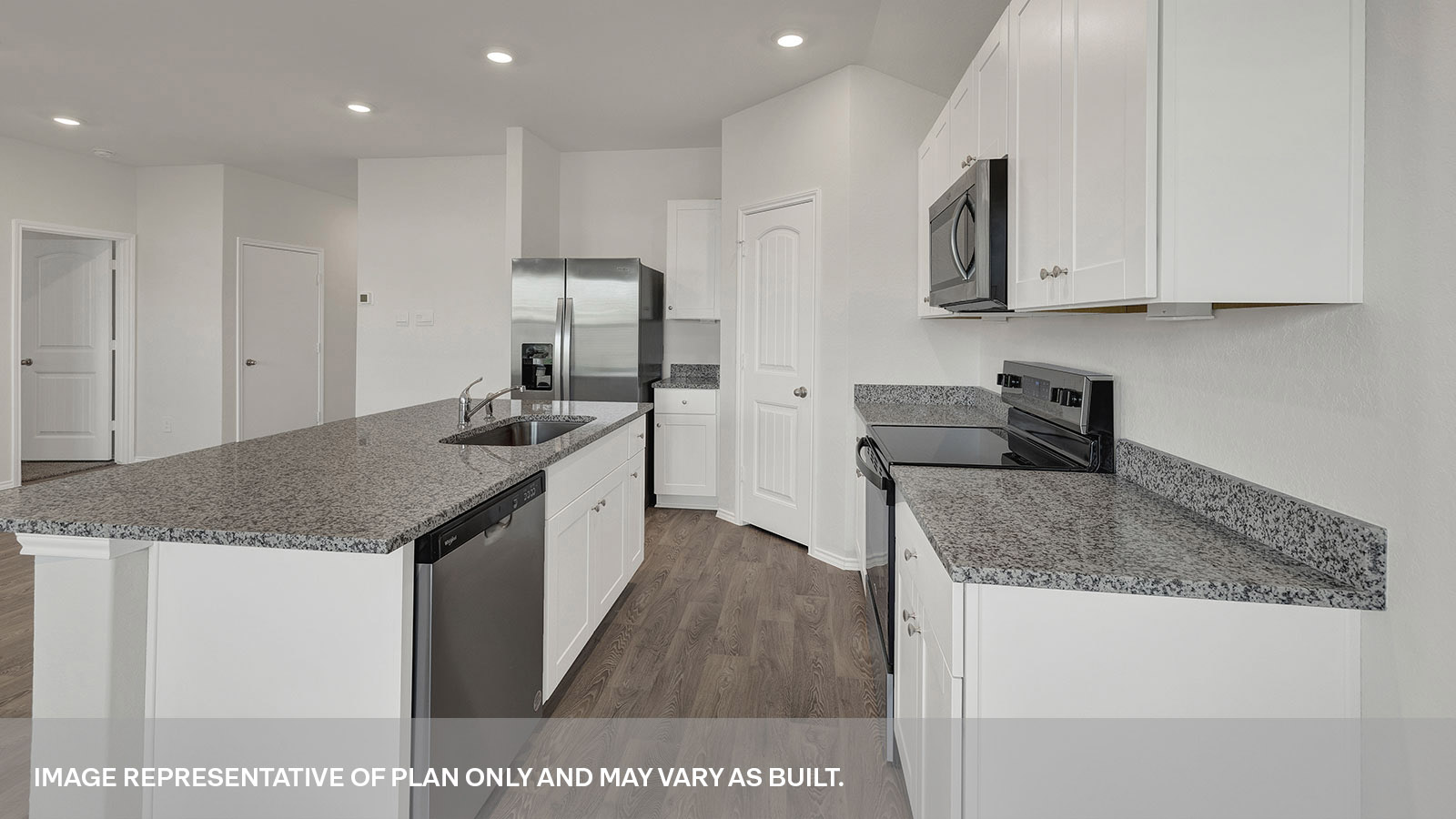 Kitchen with a kitchen island and large sink and appliances.