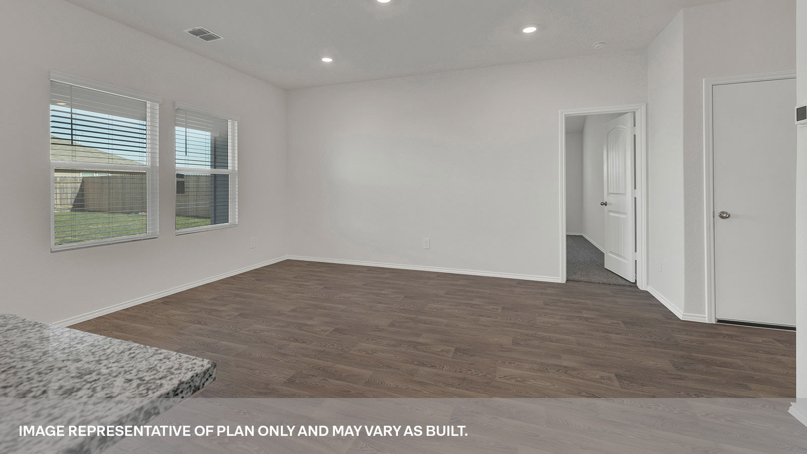 Open living room with a hallway leading to the front door.