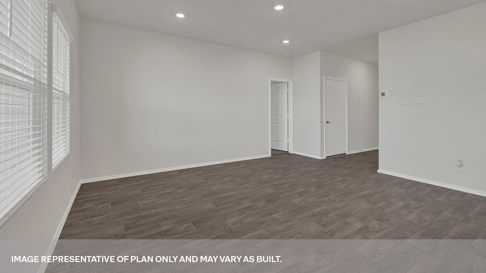 Open living room with a hallway leading to the front door.