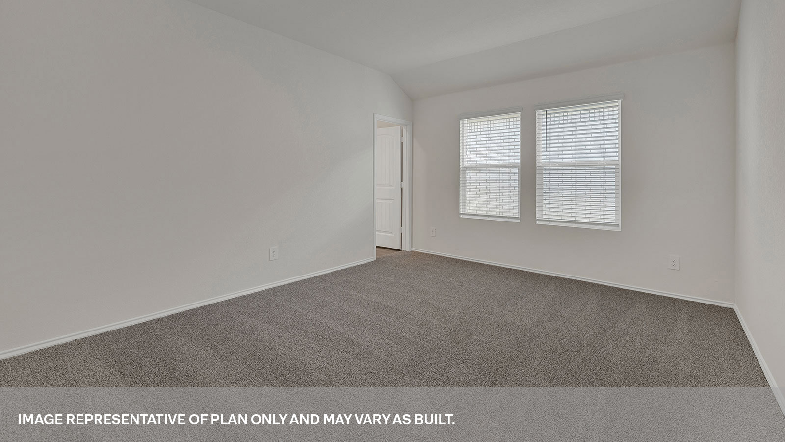 Main bedroom with carpet and two windows.