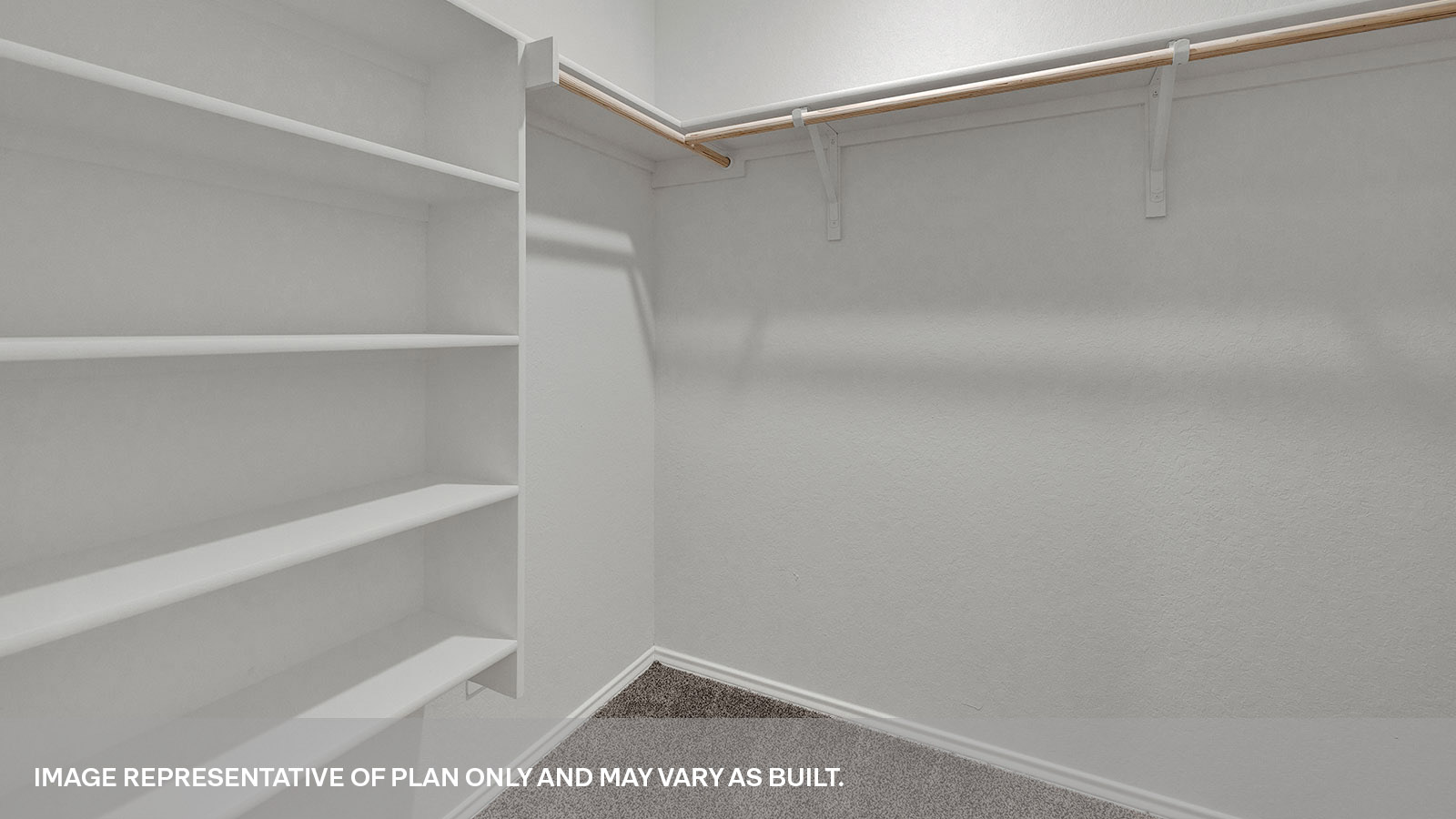 Walk-in closet with wooden shelves.