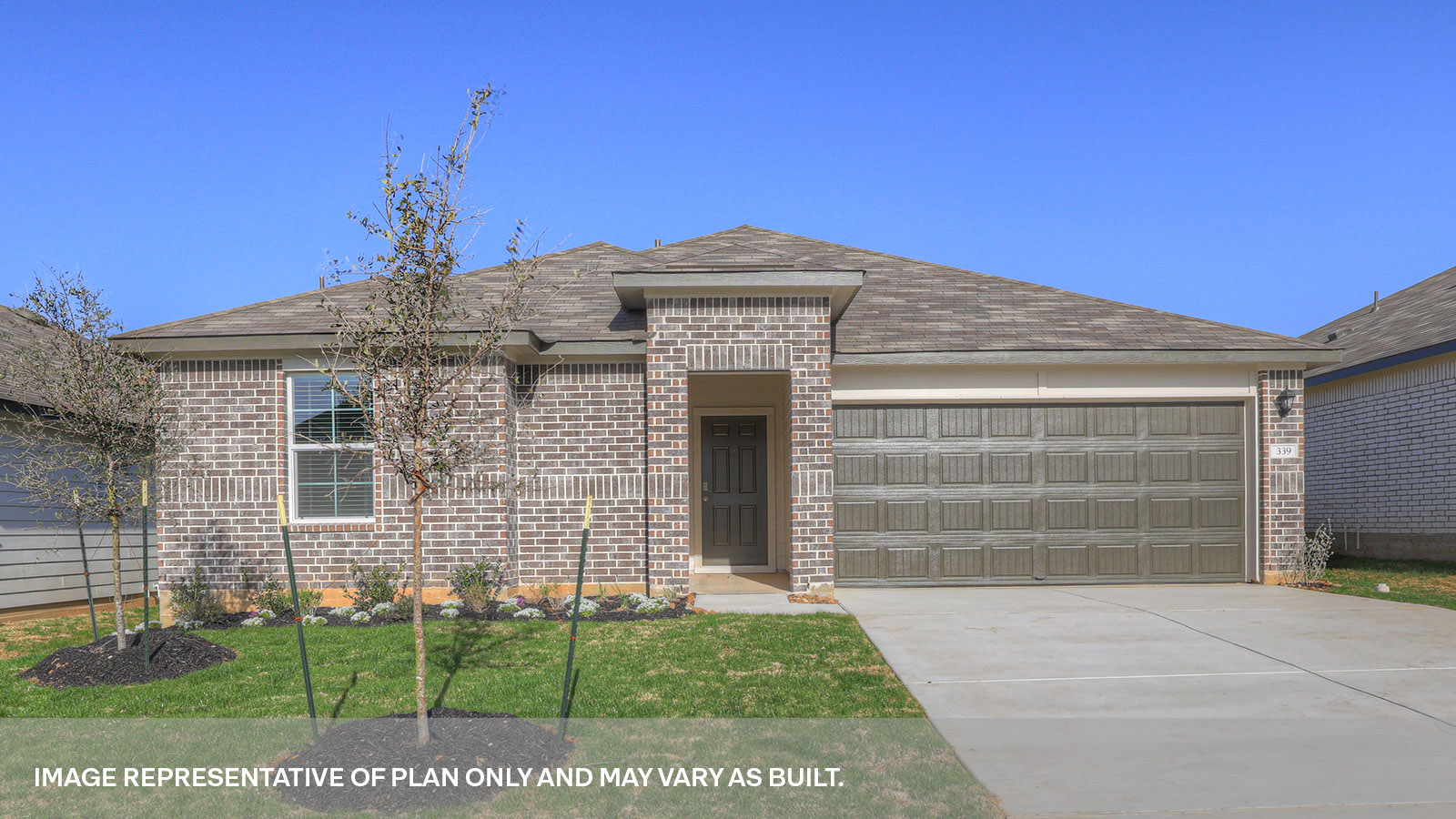 Single story home with brick, one window in the front, and a 2 car garage.
