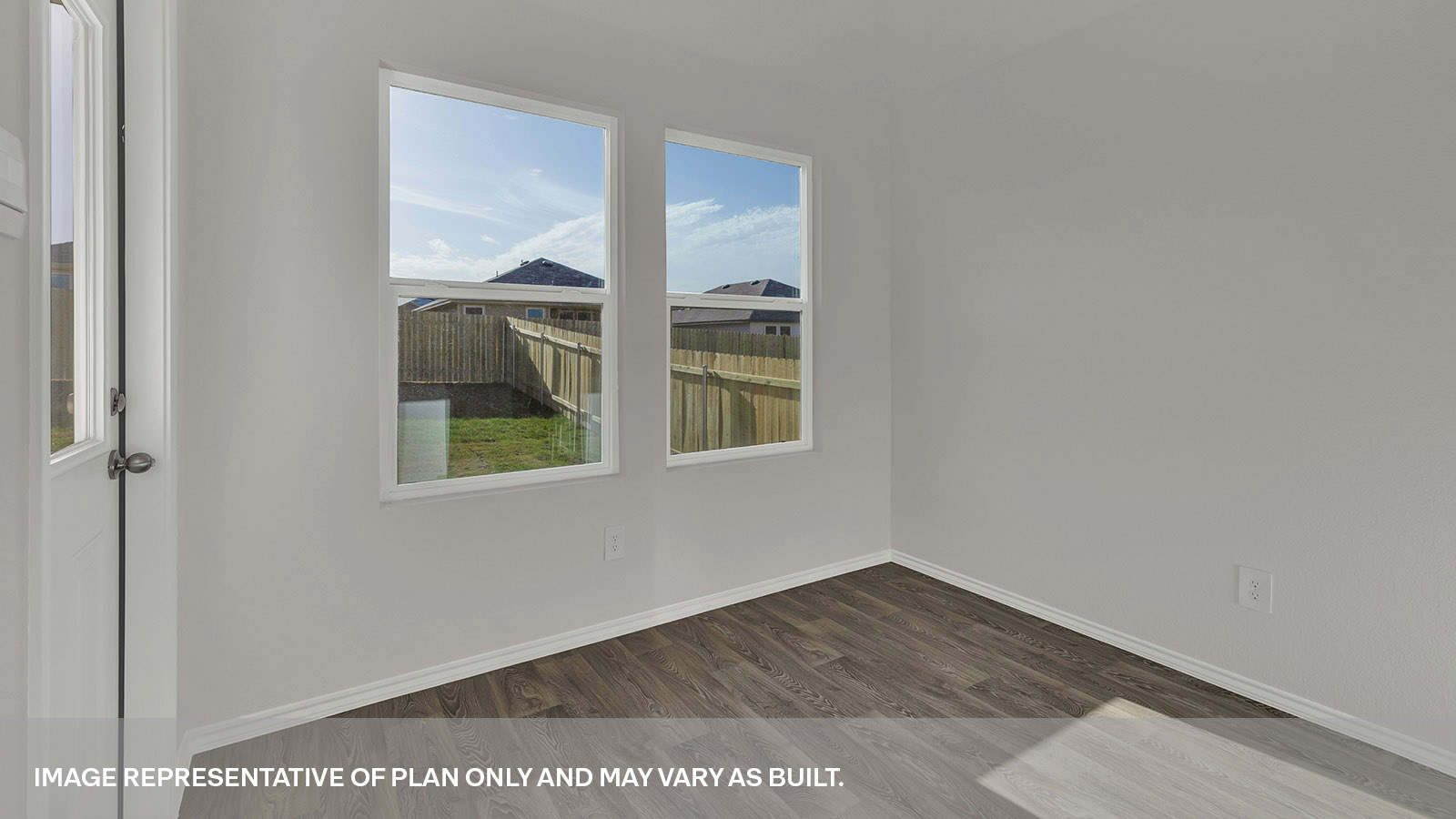 Dining area with 2 windows and a backdoor with a half-lite window.