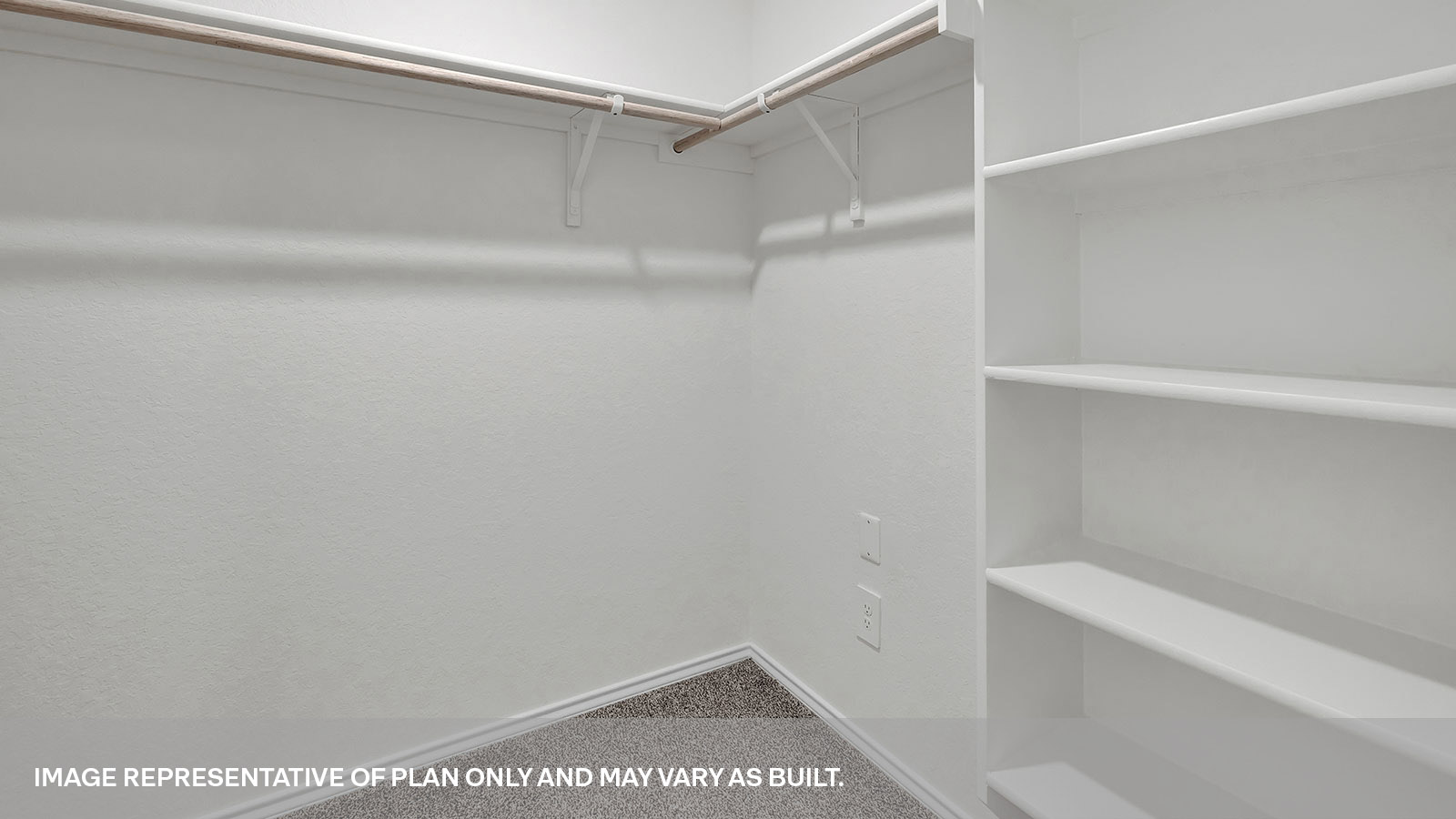 Walk-in closet with wooden shelves.