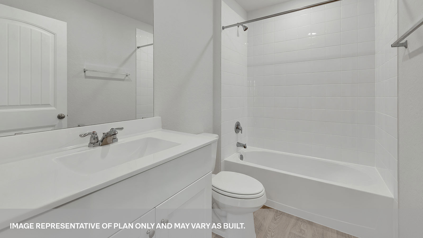 Bathroom with a tile surround shower/tub combo and white cabinets.