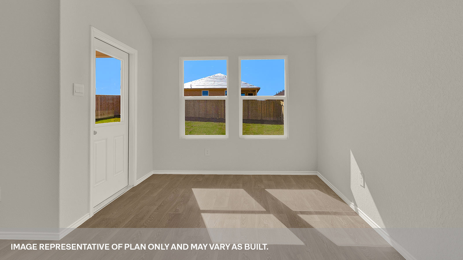 Dining area with 2 windows and a backdoor with a half-lite window.