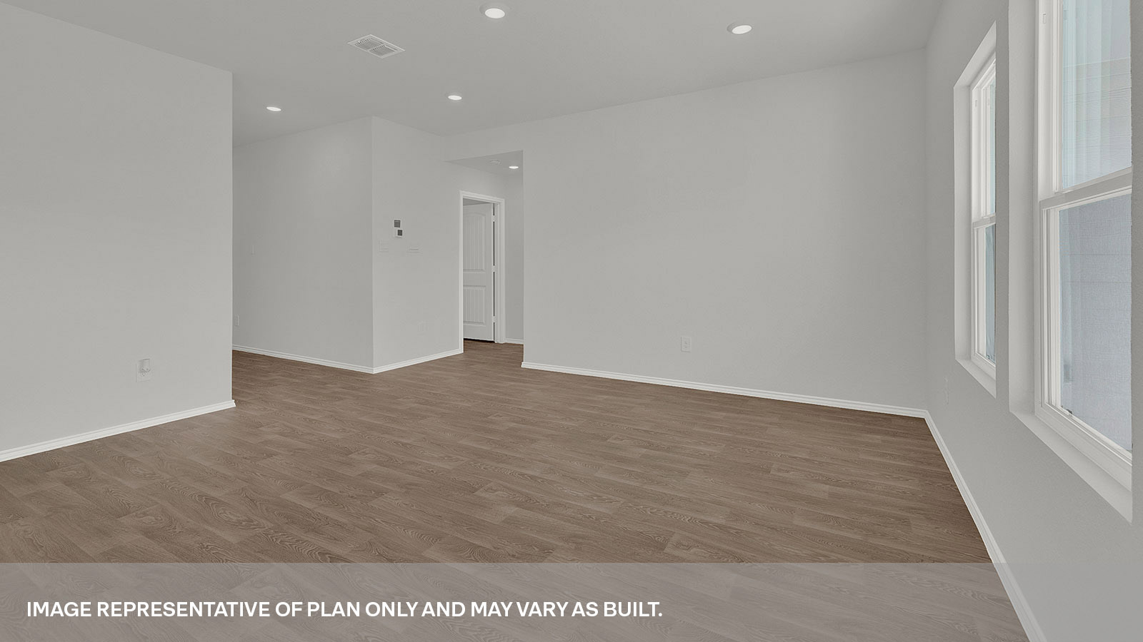 Living room leading to the front door and main bedroom.