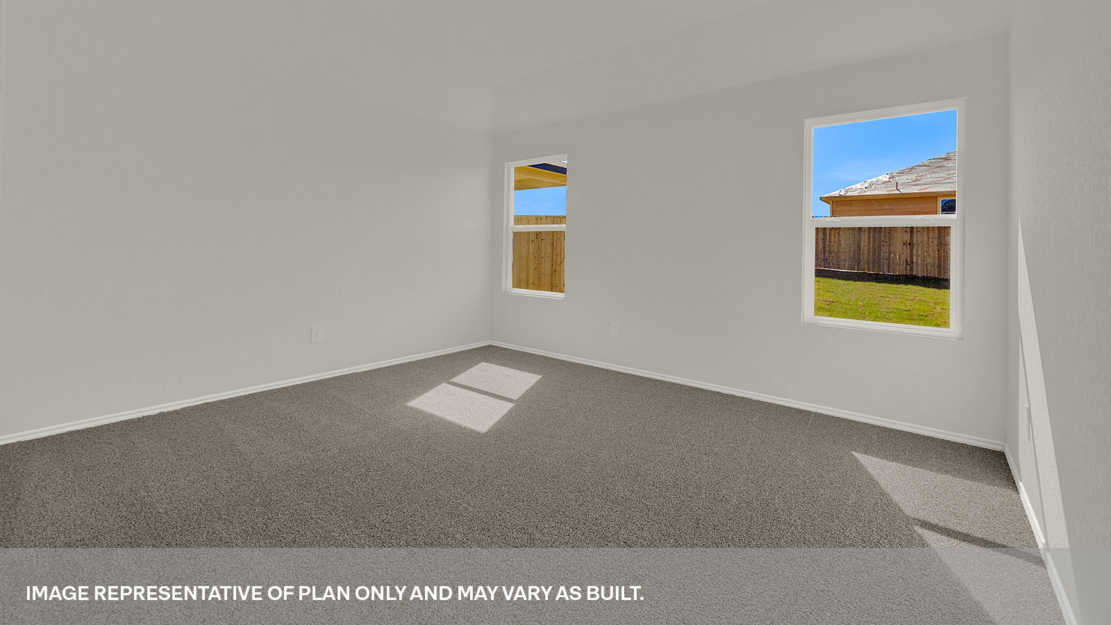 Main bedroom with carpet and two windows.