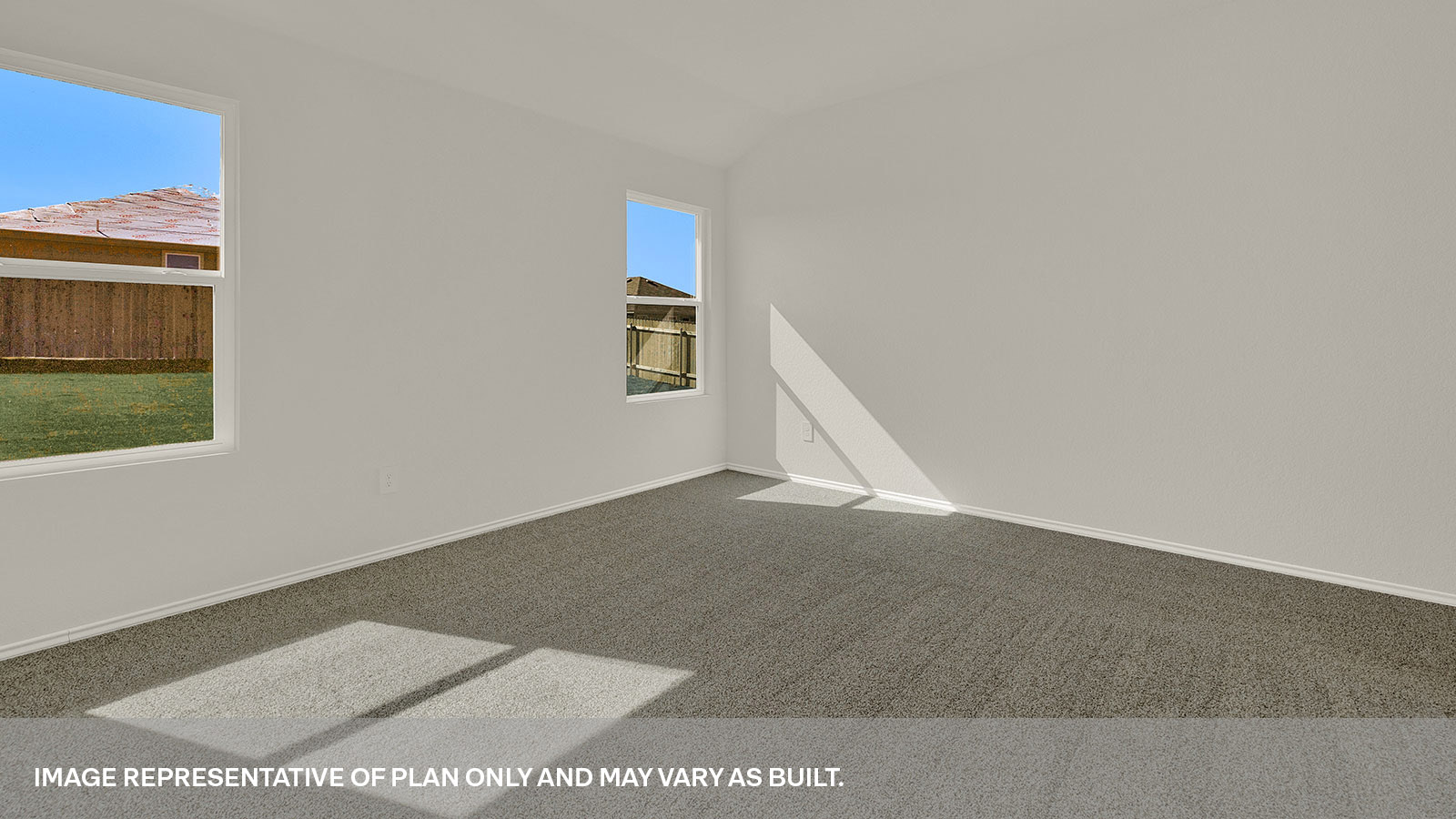 Main bedroom with carpet and two windows.