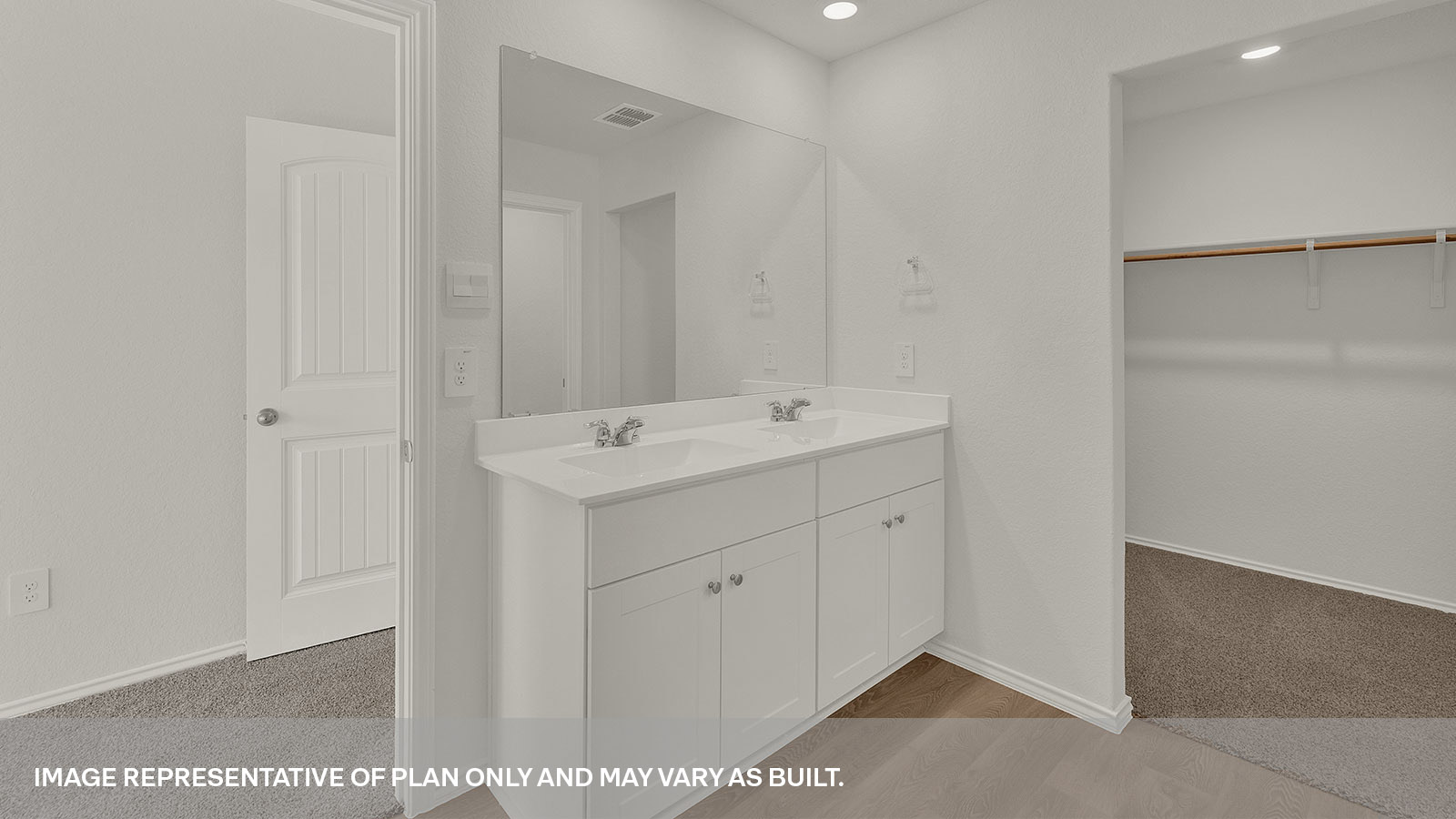 Main bathroom with a double sink, white cabinets and closet.