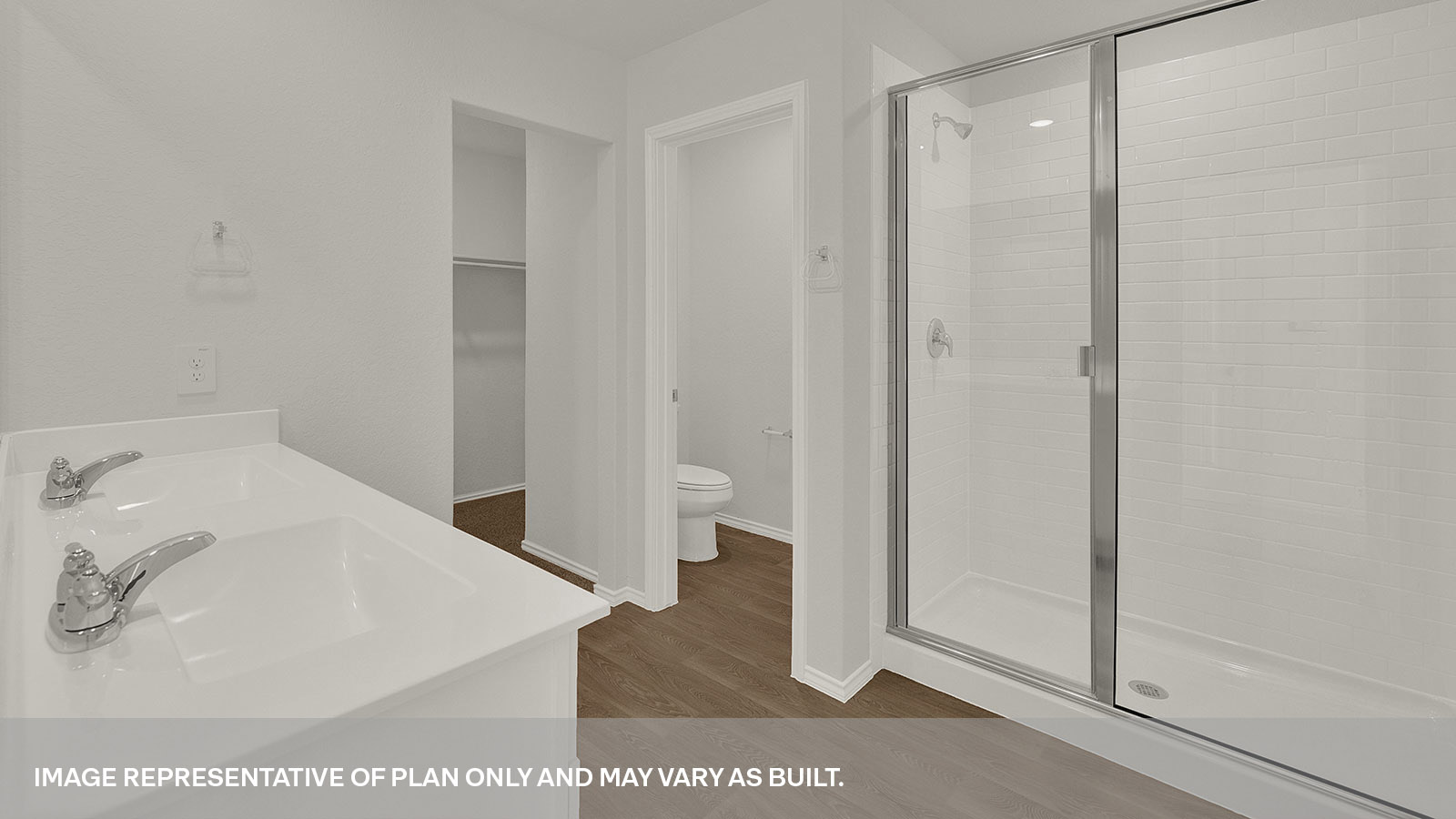 Main bathroom with double sink vanity, closet, toilet,  and walk-in shower.