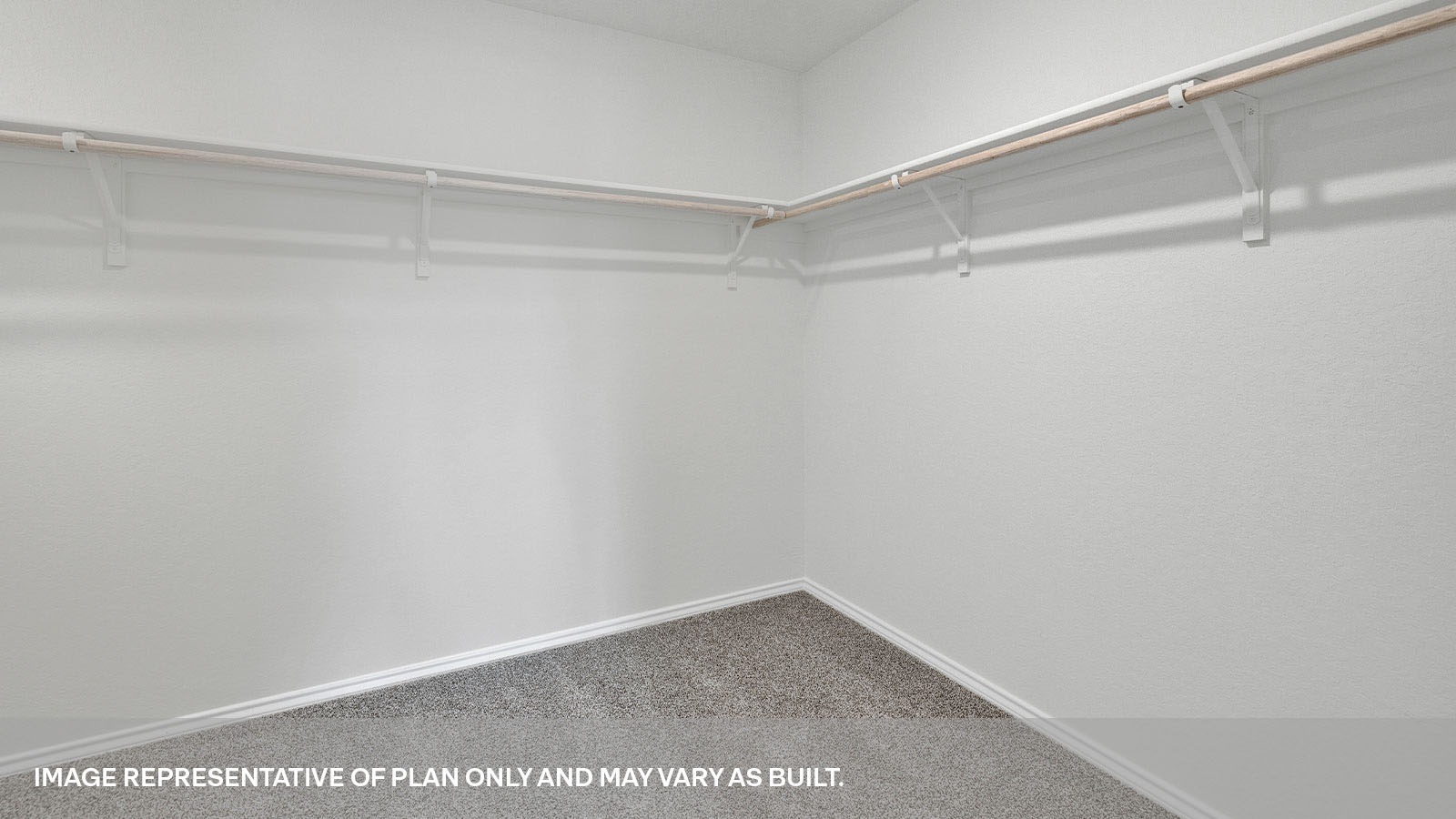 Closet with carpeting and wooden shelving.