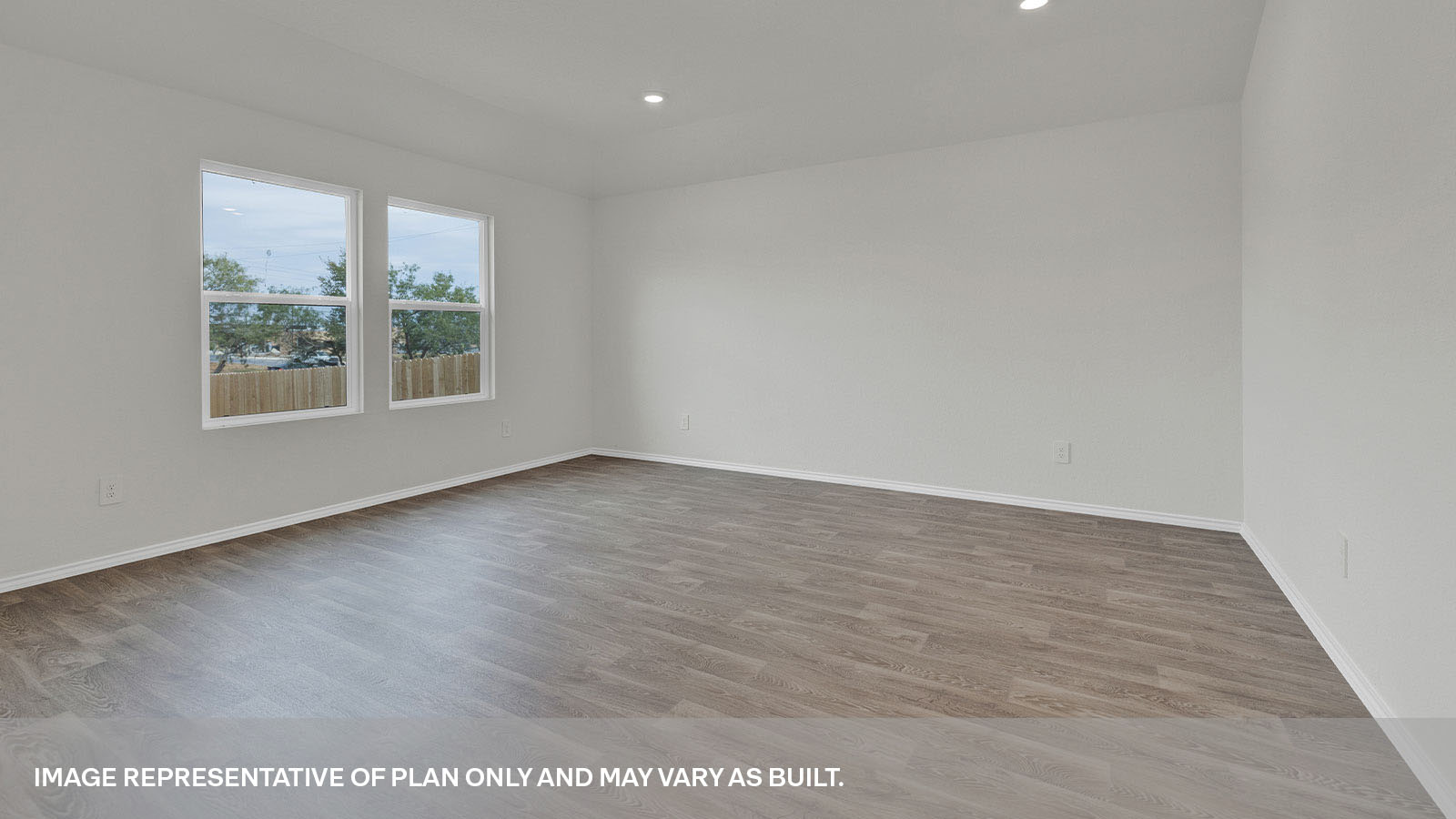 Living room with vinyl flooring and two windows.