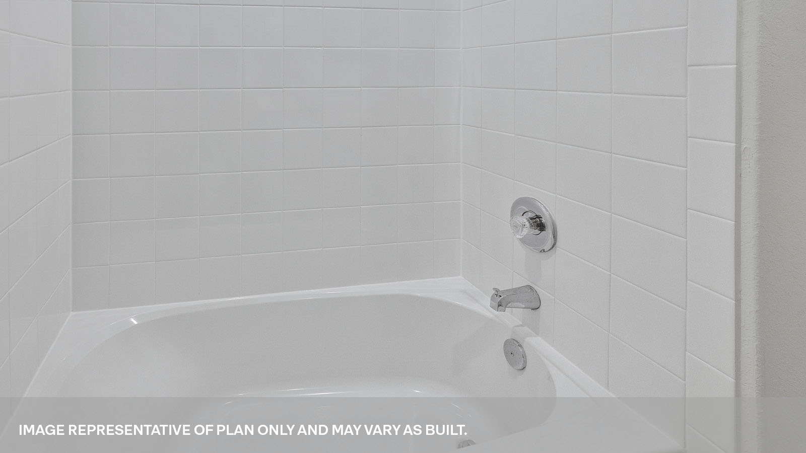 Hall bathroom tub with tile surround.