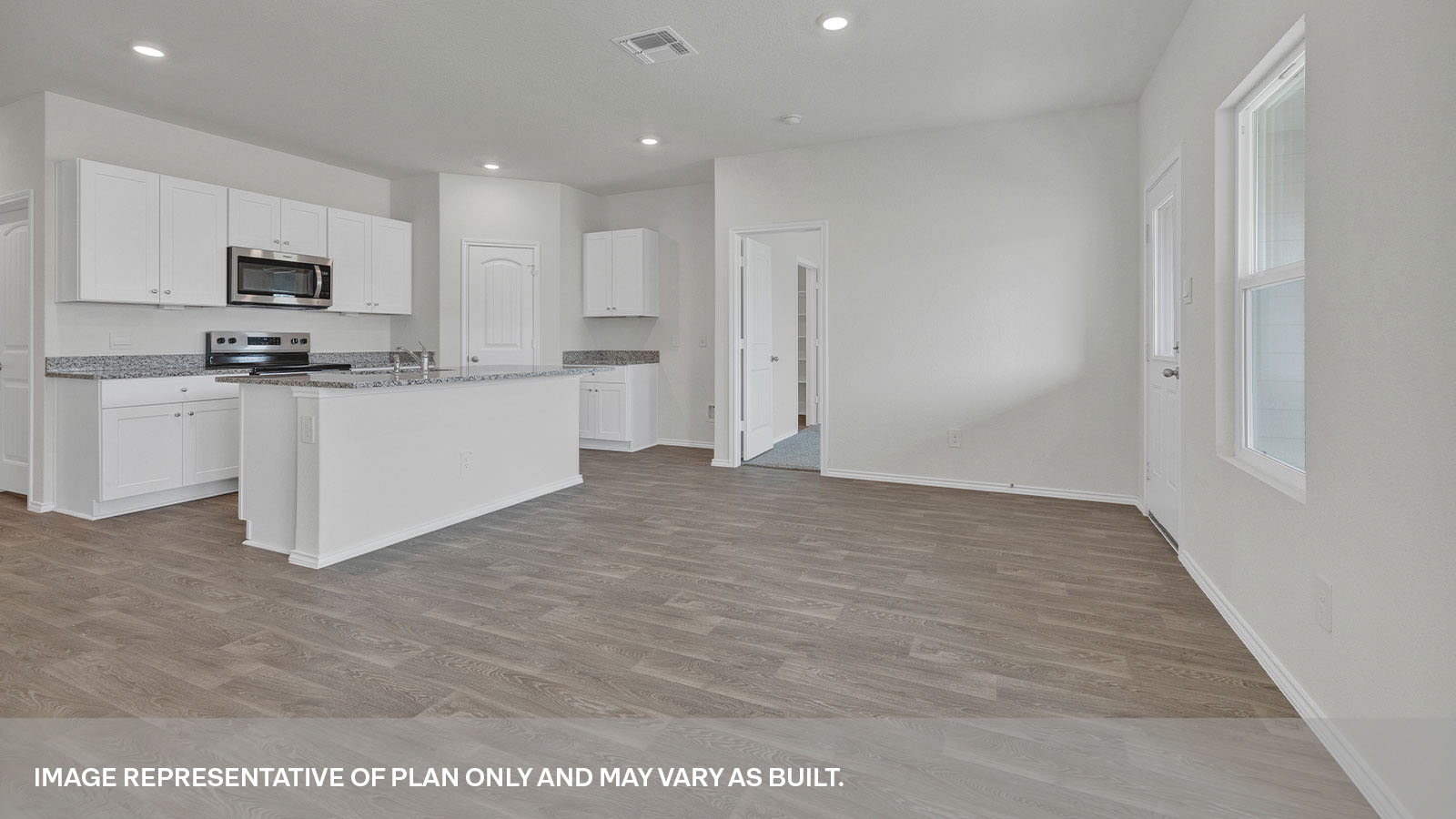 Main bedroom with carpeting and two windows.