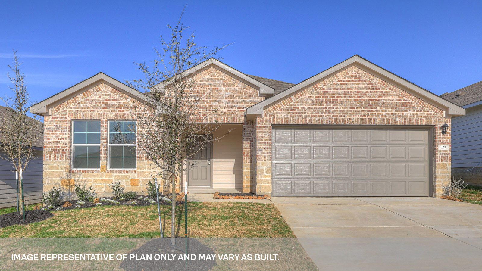 Single story home with brick, one window in the front, and a 2 car garage.