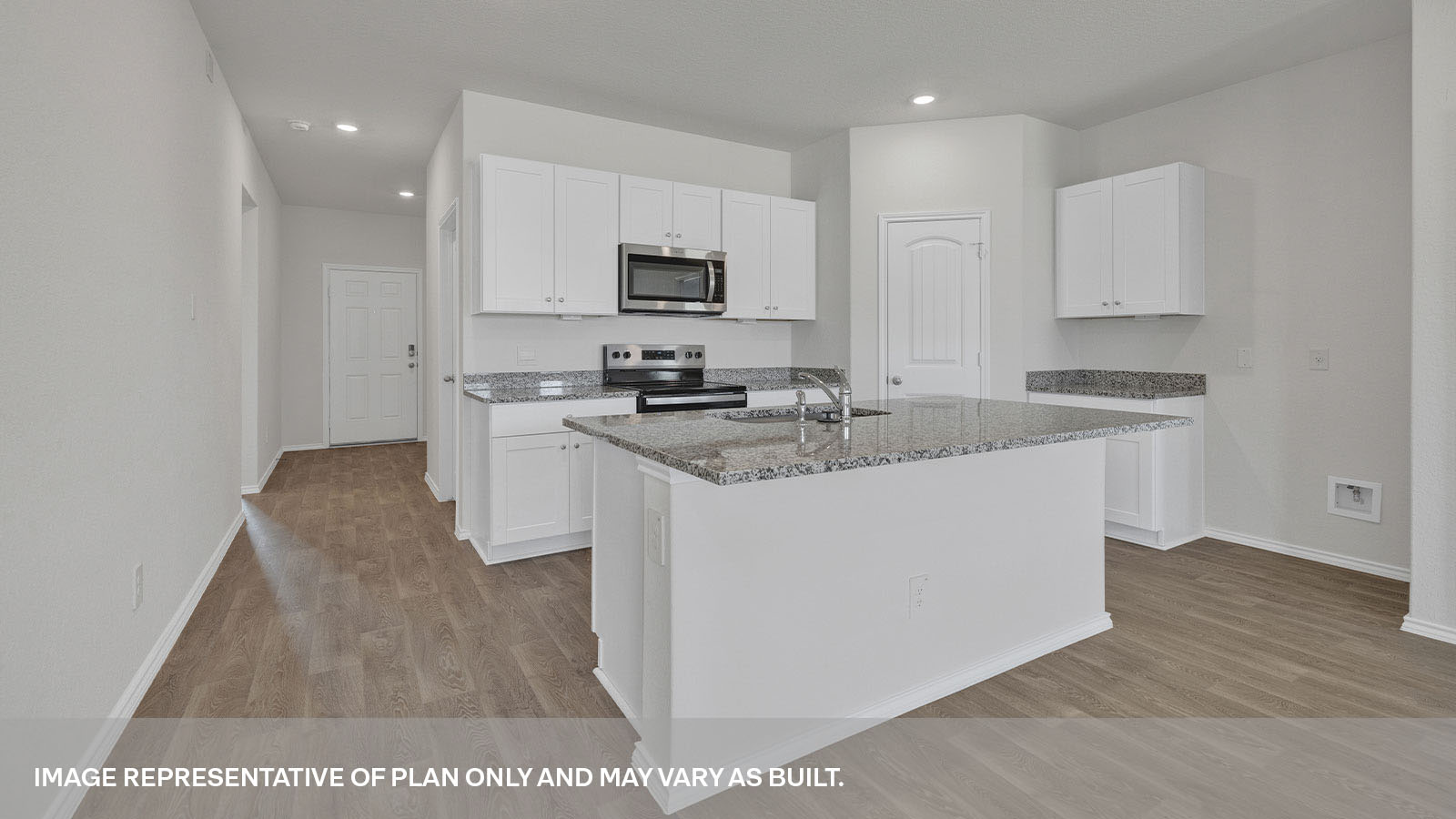 Kitchen with kitchen island and entry hallway.