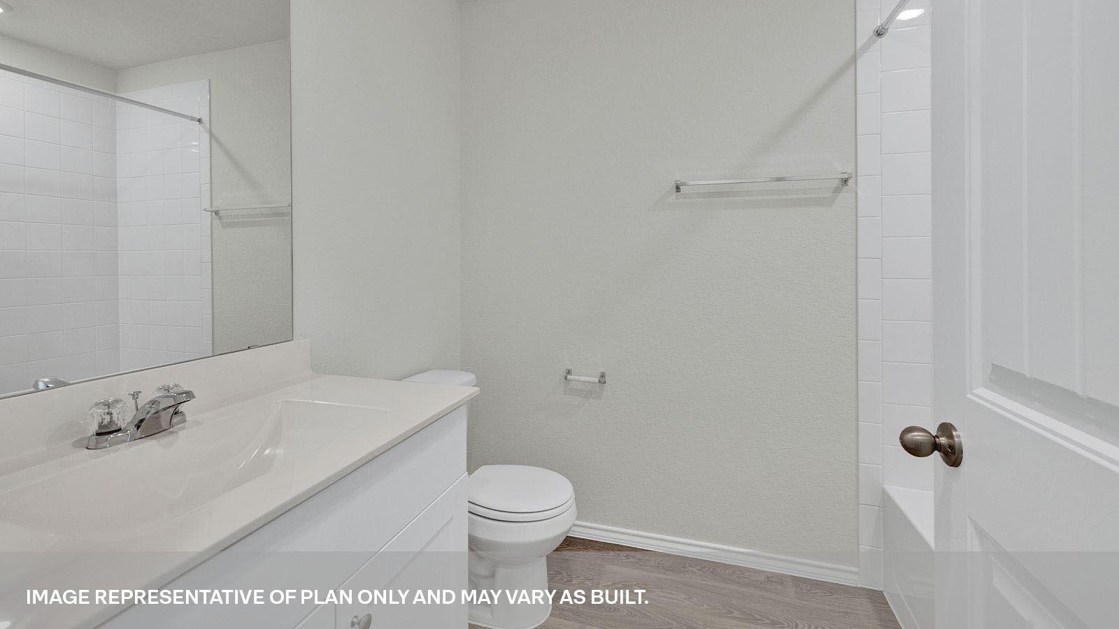 Hall bathroom with single sink vanity, toilet, and tub.