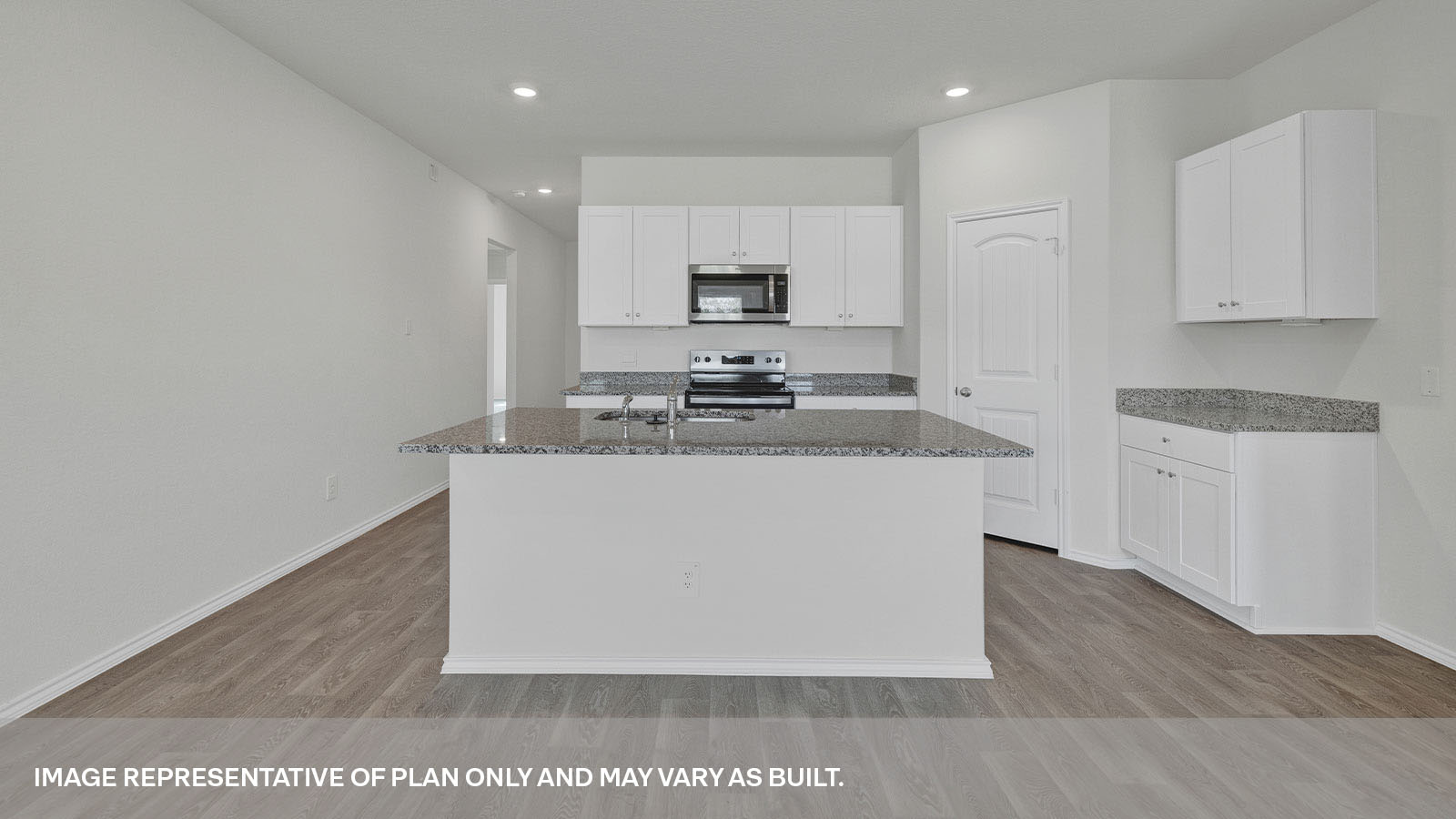 Kitchen with kitchen island and white cabinets.