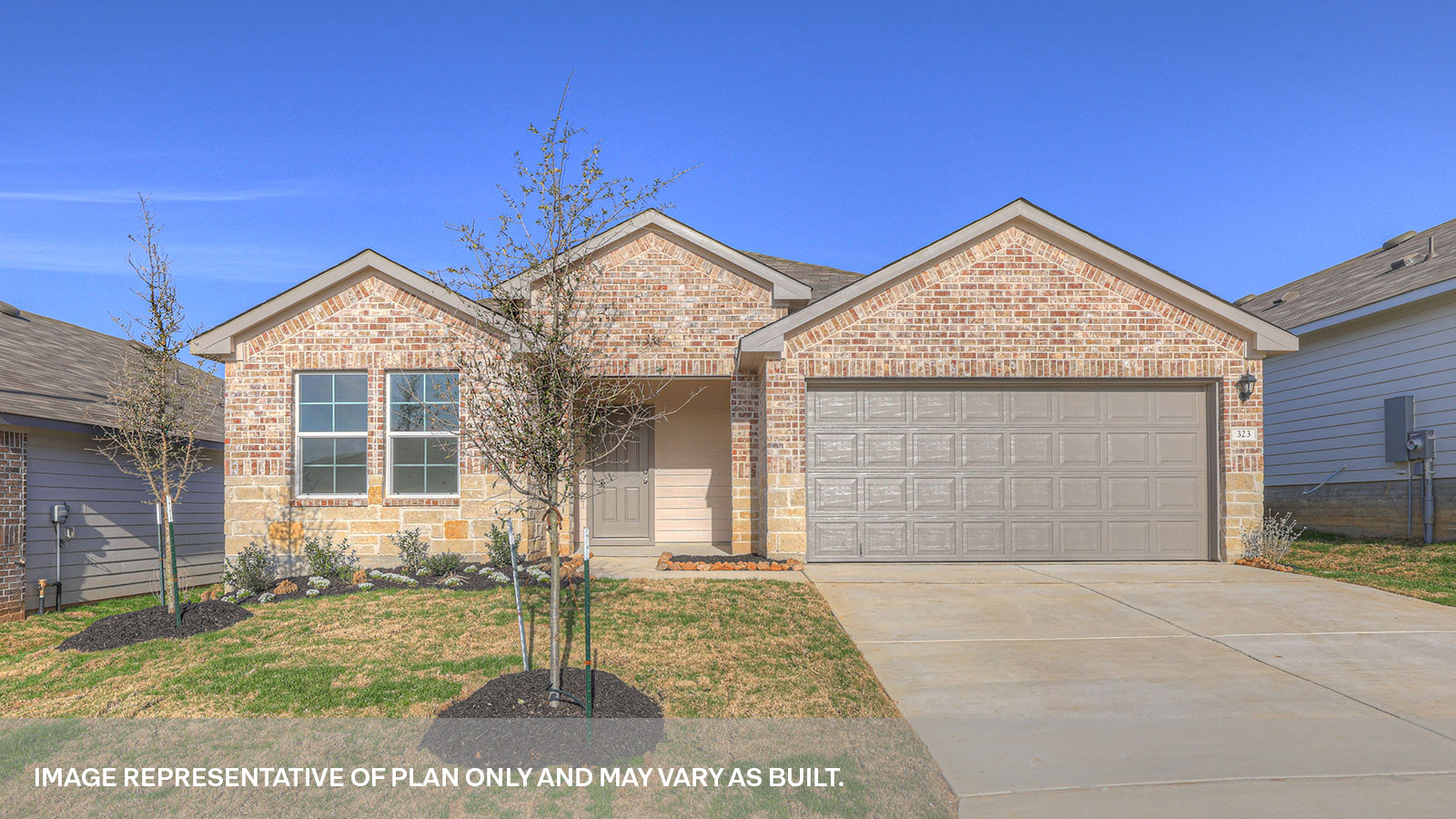 Single story home with brick, one window in the front, and a 2 car garage.