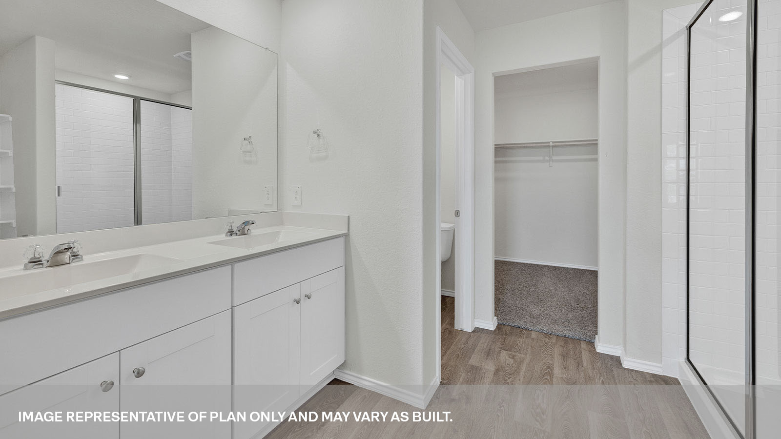 Main bathroom with double sink vanity, shower, and water closet.