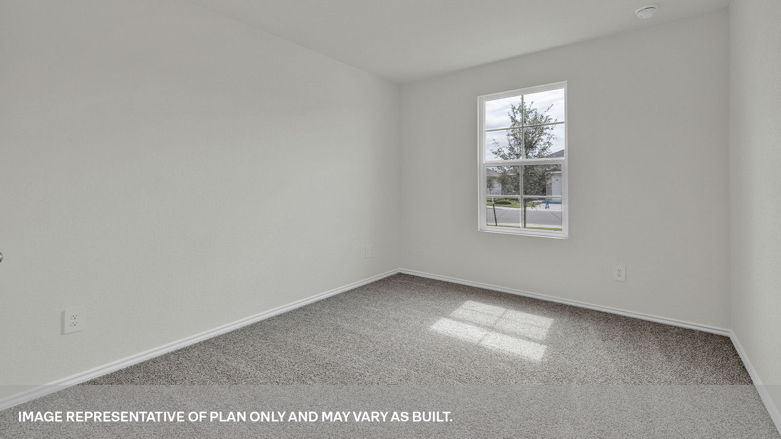 Front bedroom with carpeting and one window.