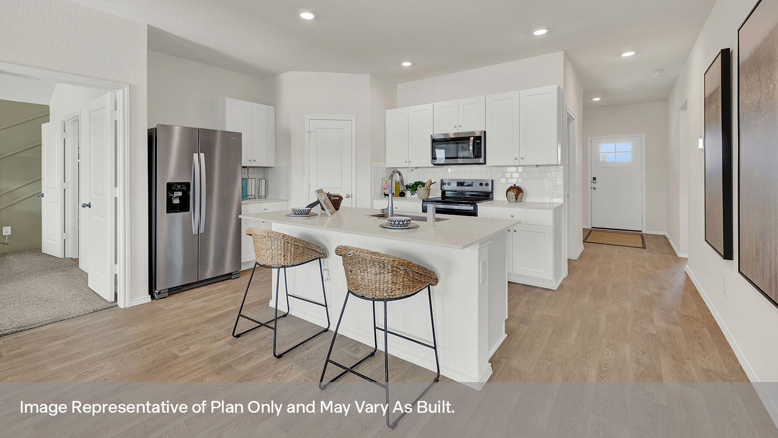Kitchen with kitchen island and entry hallway.