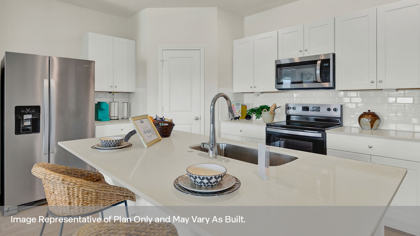 Kitchen with white cabinets, appliances, and quartz countertops.