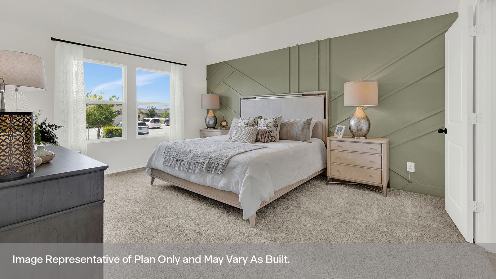 Main bedroom with carpeting and two windows.