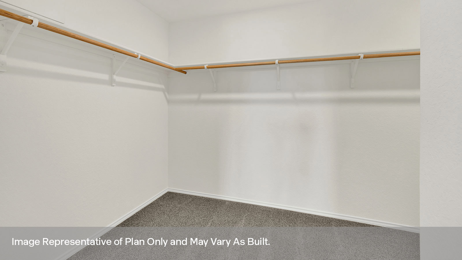 Closet with carpeting and wooden shelving.