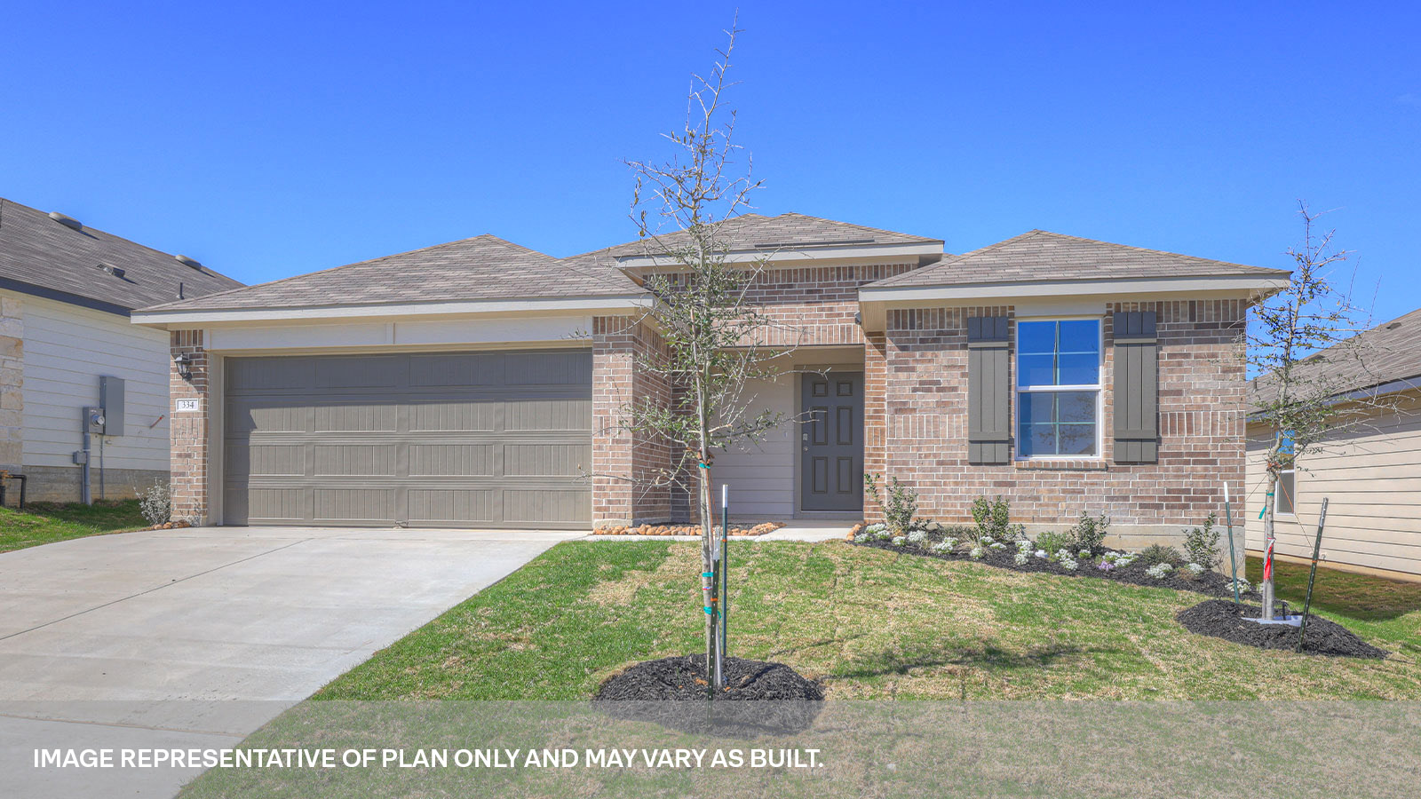 Single story home with brick, one window in the front, and a 2 car garage.